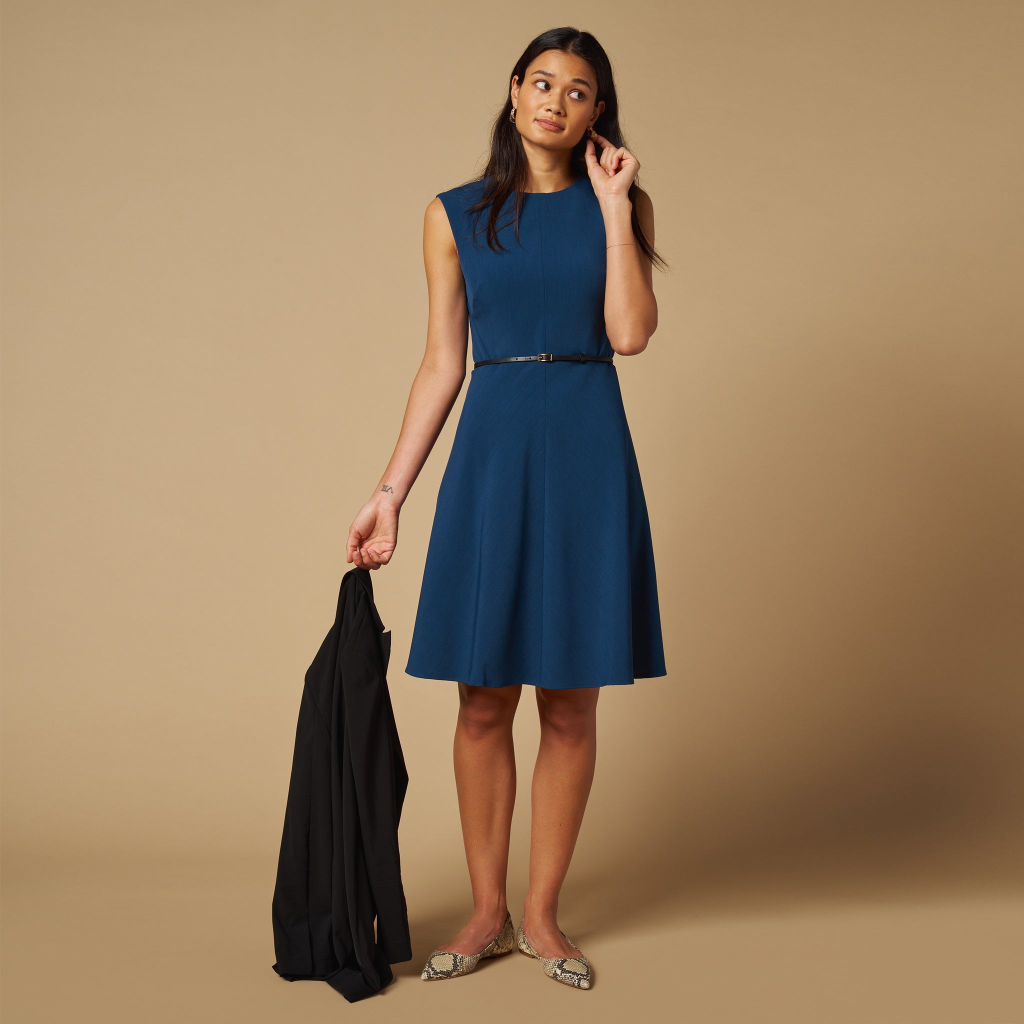 mood image of a woman wearing the toi dress in deep teal