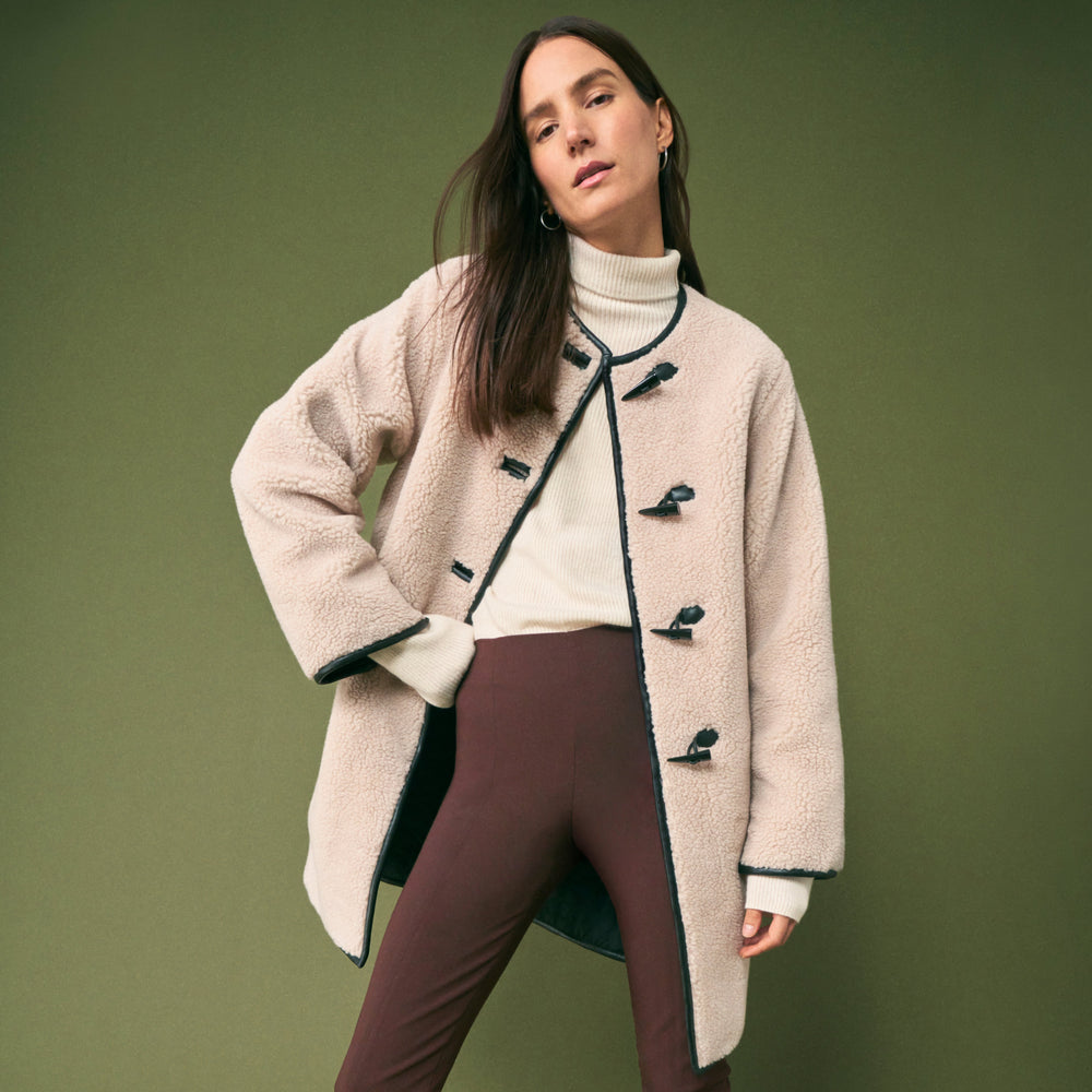 front image of a woman wearing the katari jacket in travertine