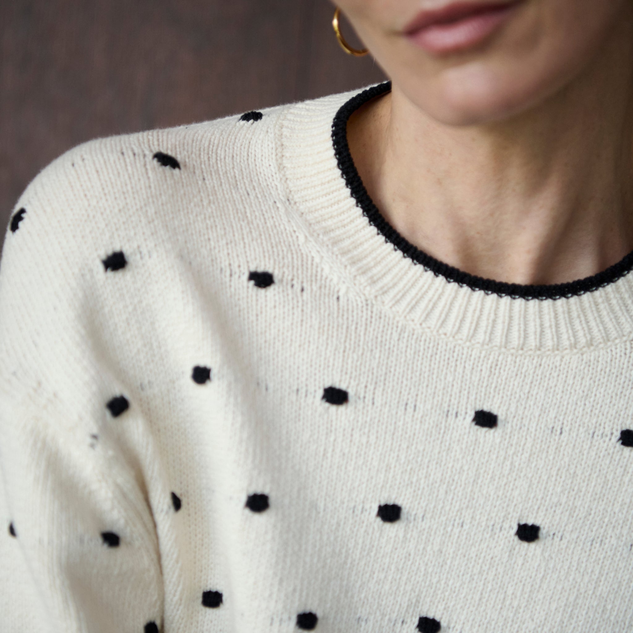 front image of a woman wearing the kim sweater in dot knit