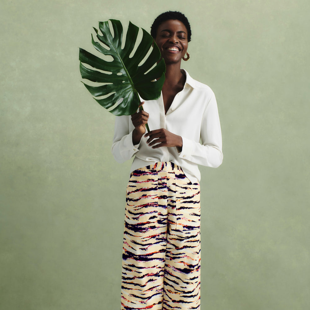 front image of a woman wearing the madelyn pant in savannah print