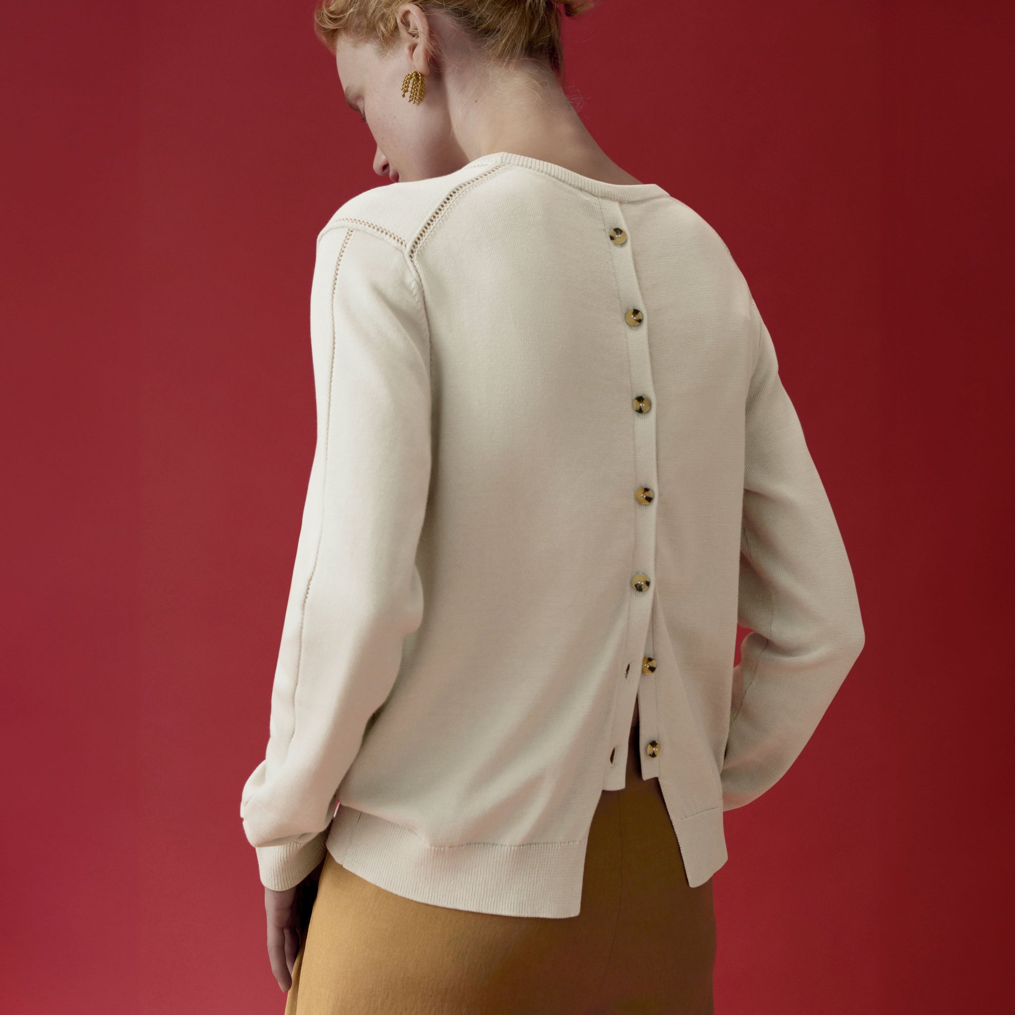 back image of a woman wearing the larissa sweater in ivory