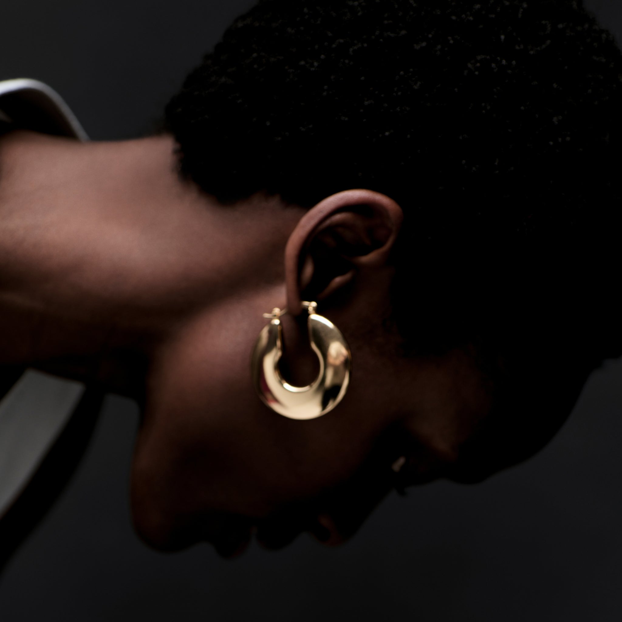 image of a woman wearing the lennon earring in gold
