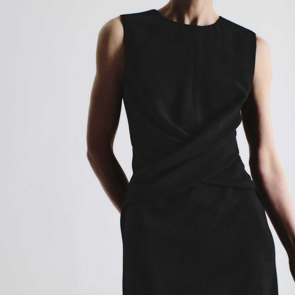 front image of a woman wearing the luz dress in black