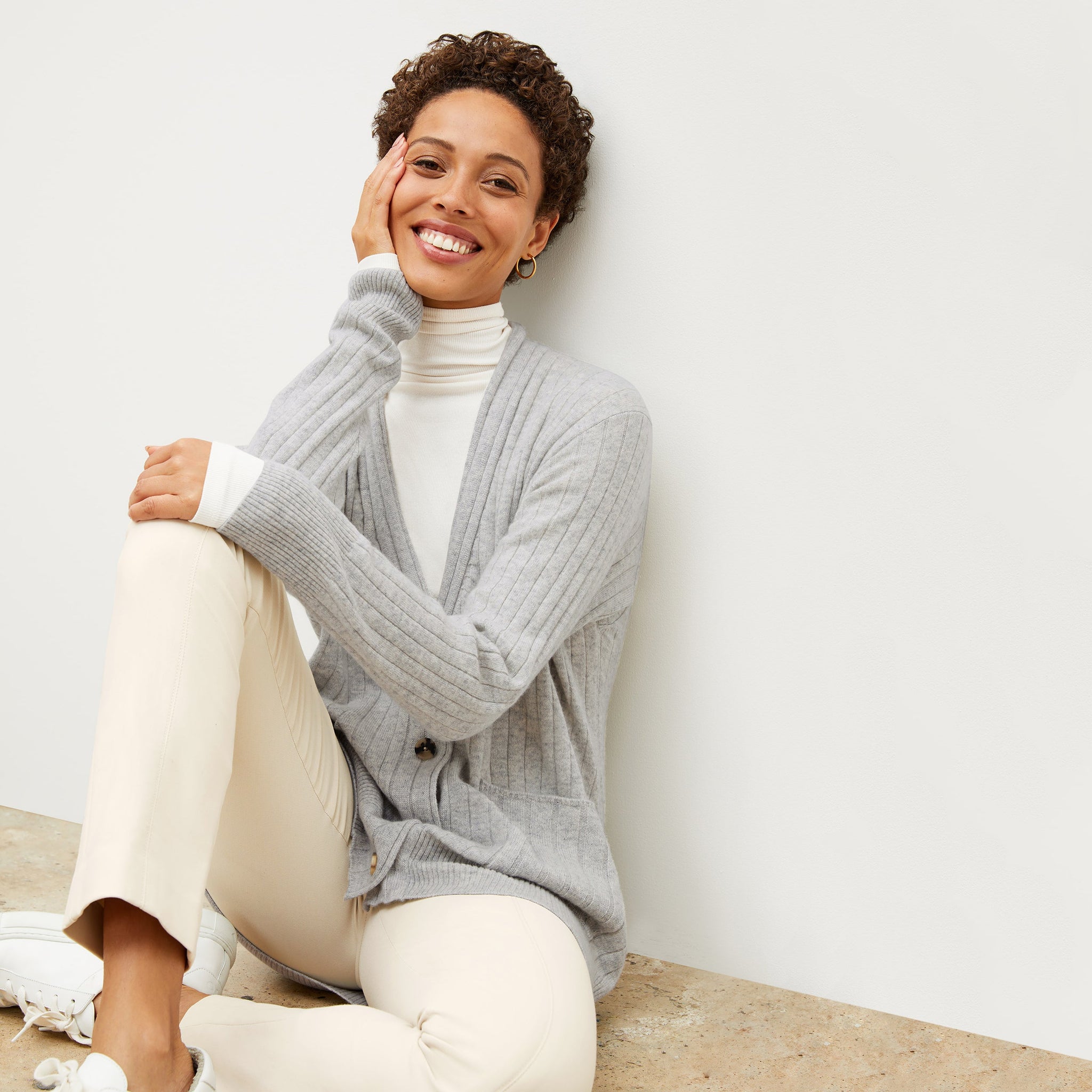 Front image of a woman standing wearing the axam top in ivory