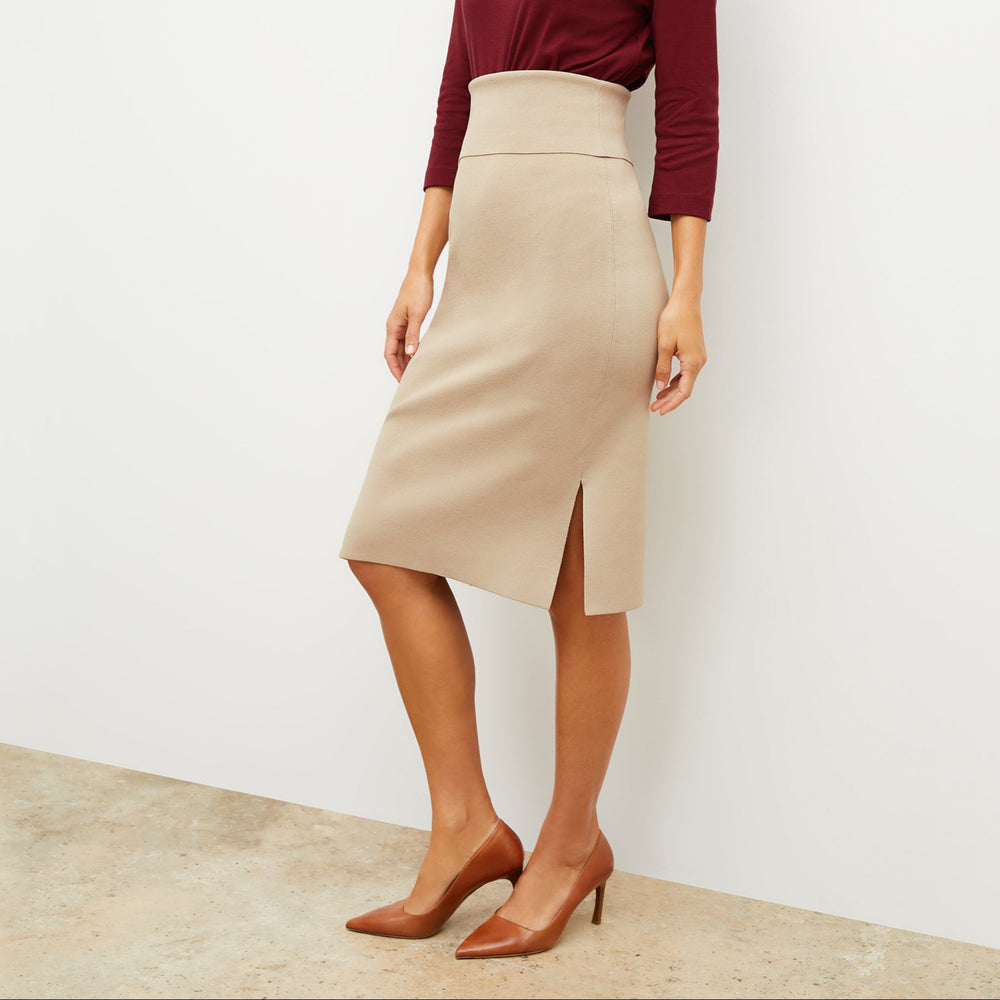 Front image of a woman standing wearing the Harlem skirt in latte