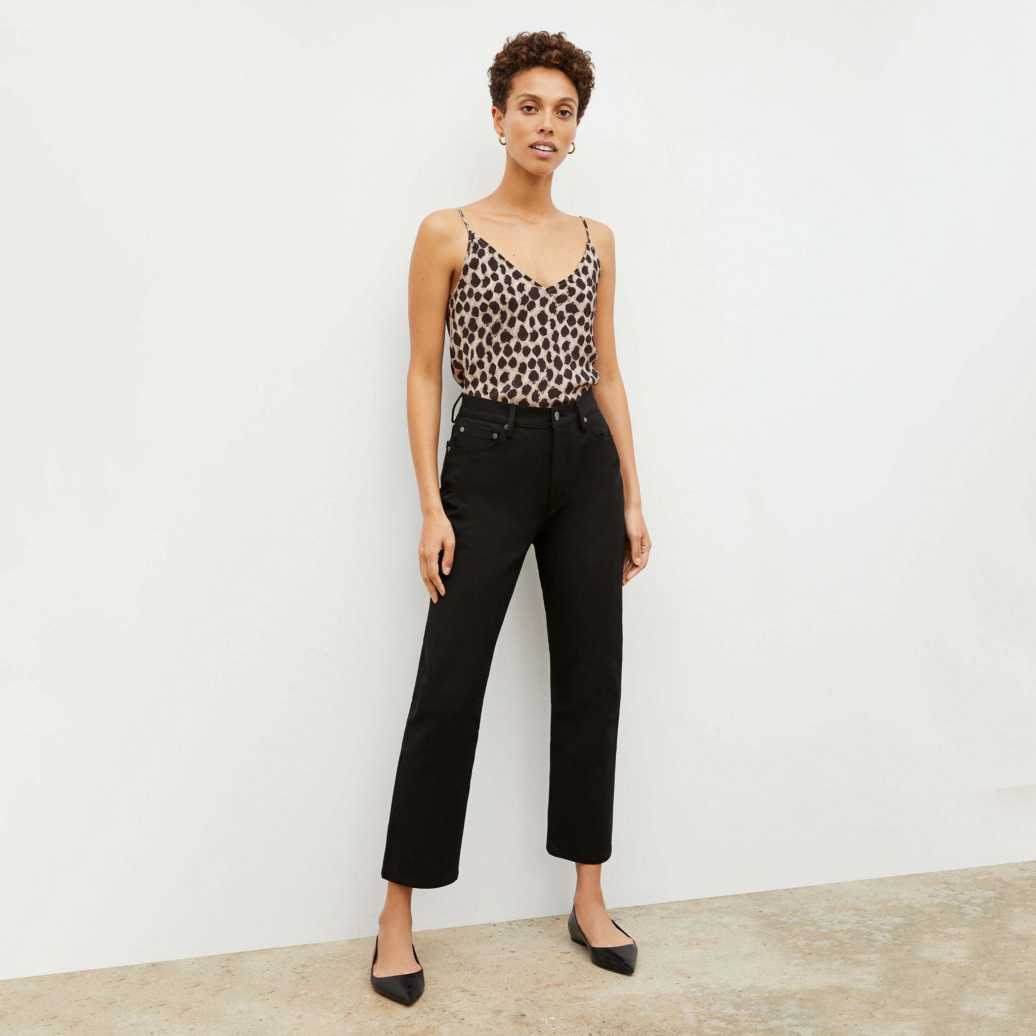 Front image of a woman in the daria pant in black 