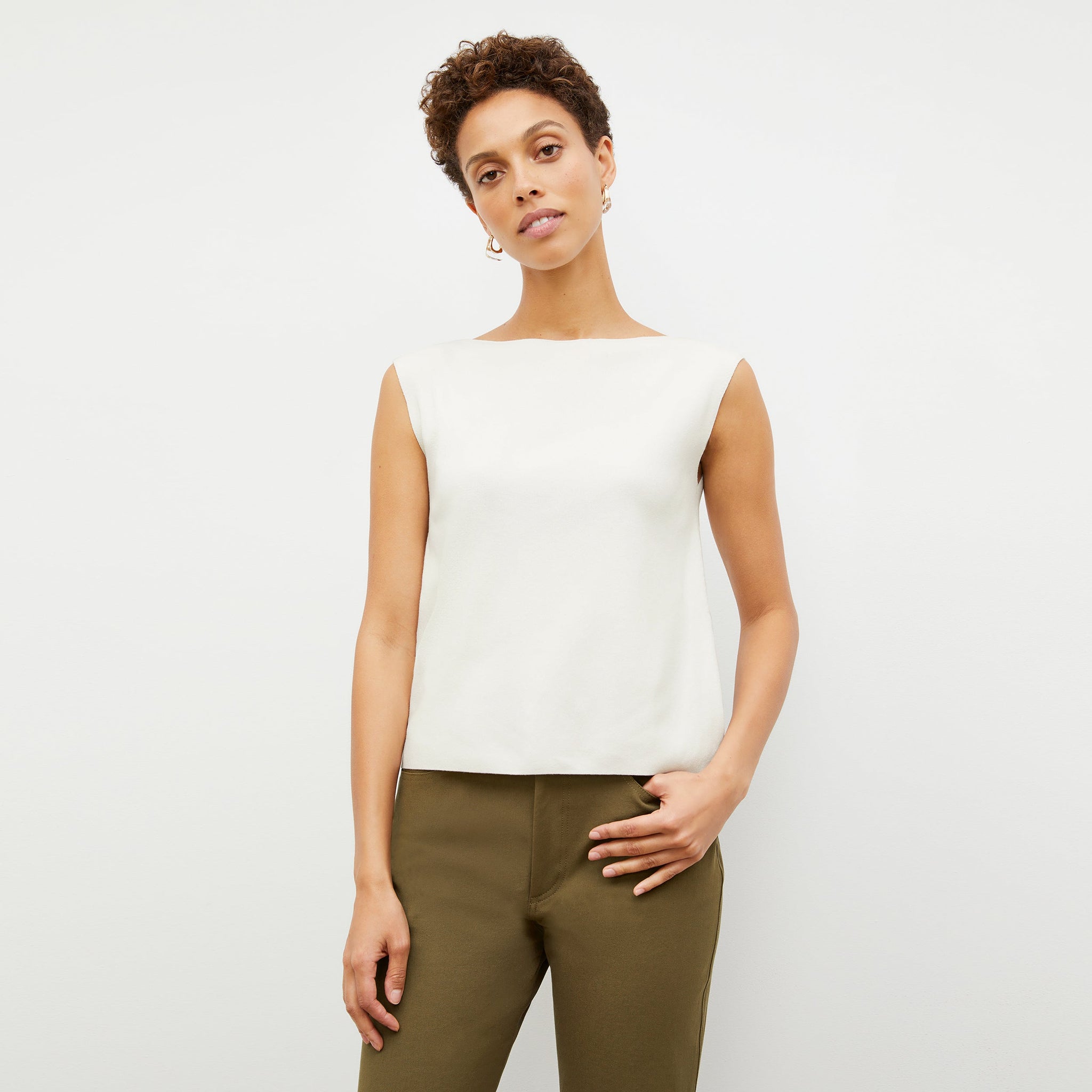 Front image of a woman standing wearing the Eileen Top in ivory 