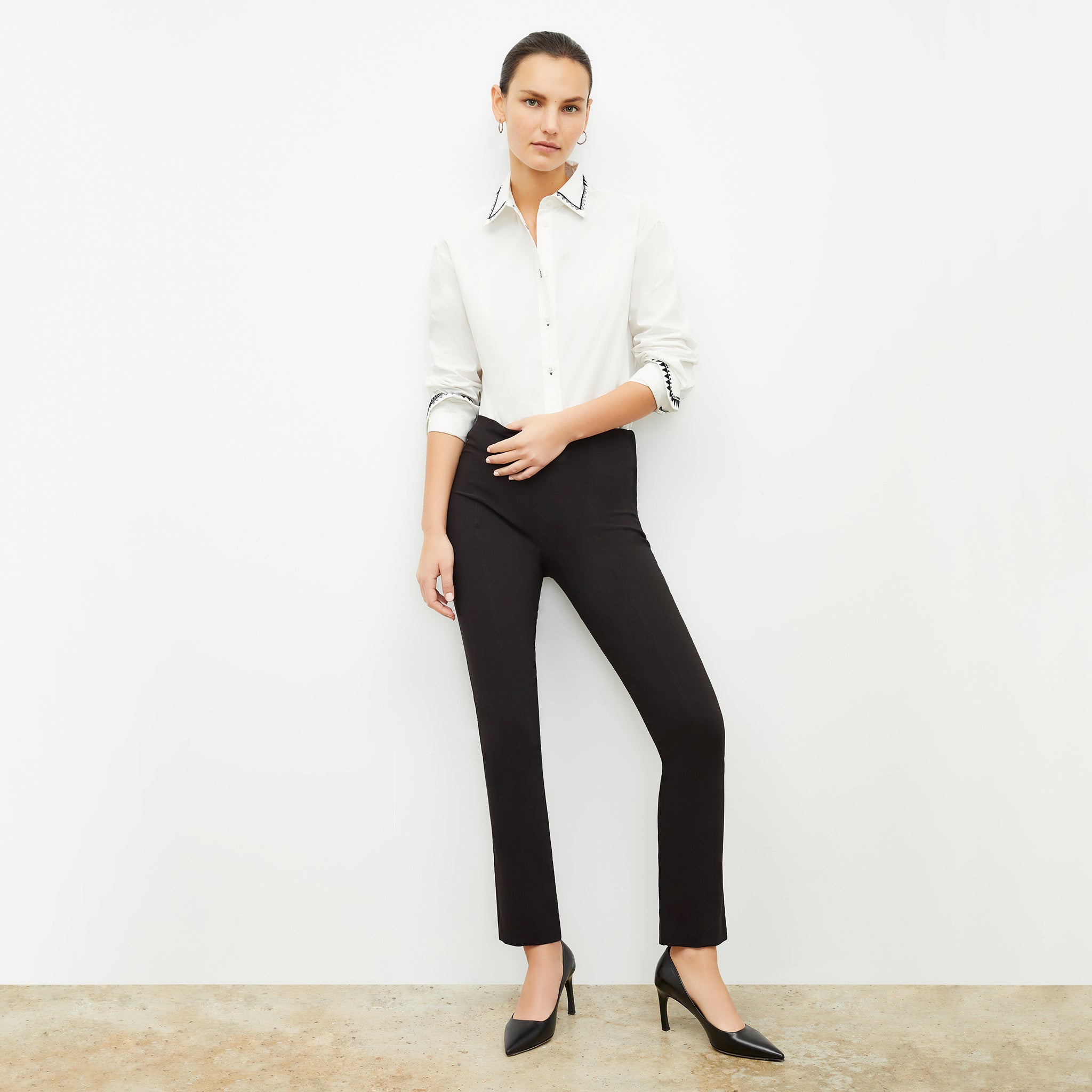 Front image of a woman standing wearing the Foster Pant—Everstretch in Black