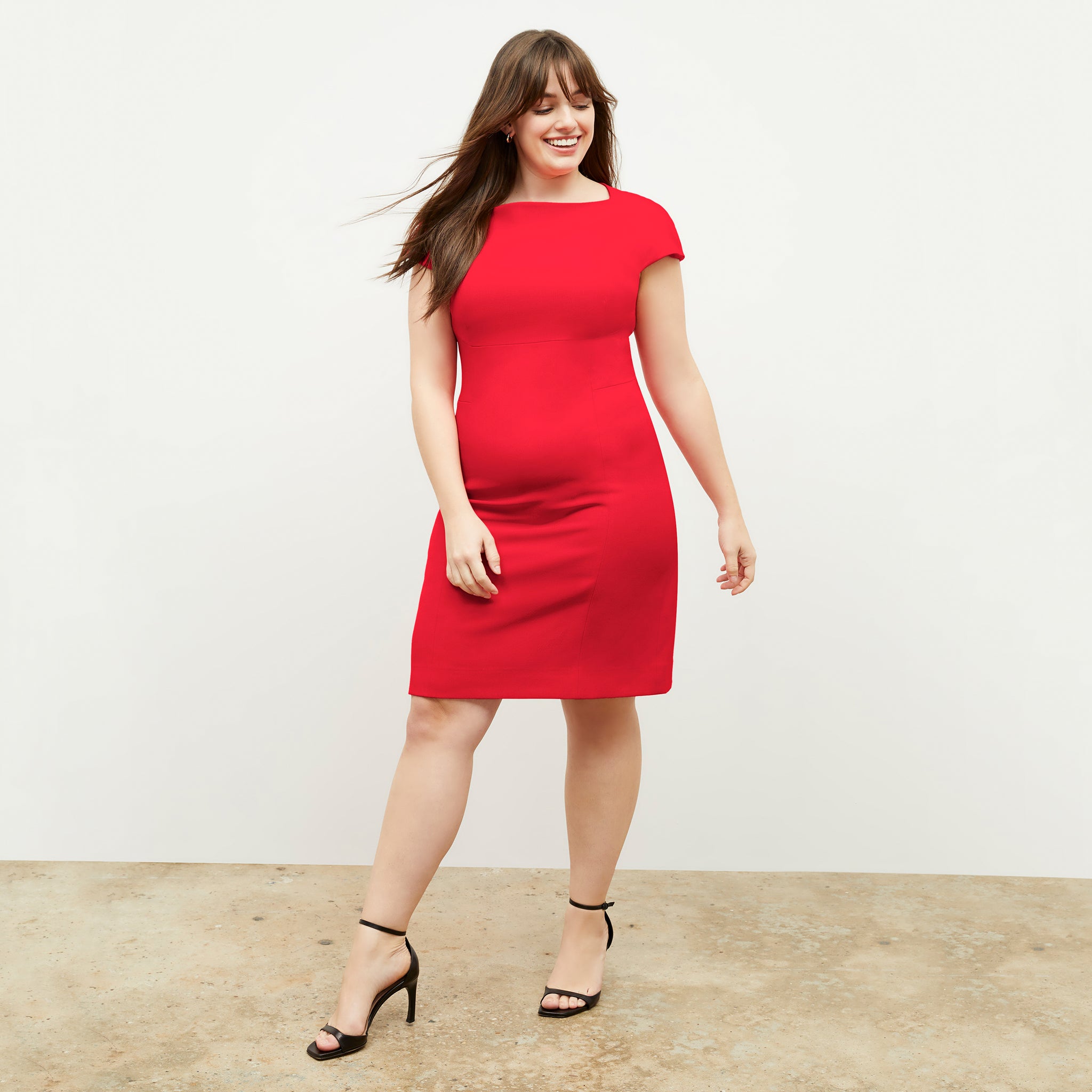 Front image of a woman wearing the ashley dress in flame 