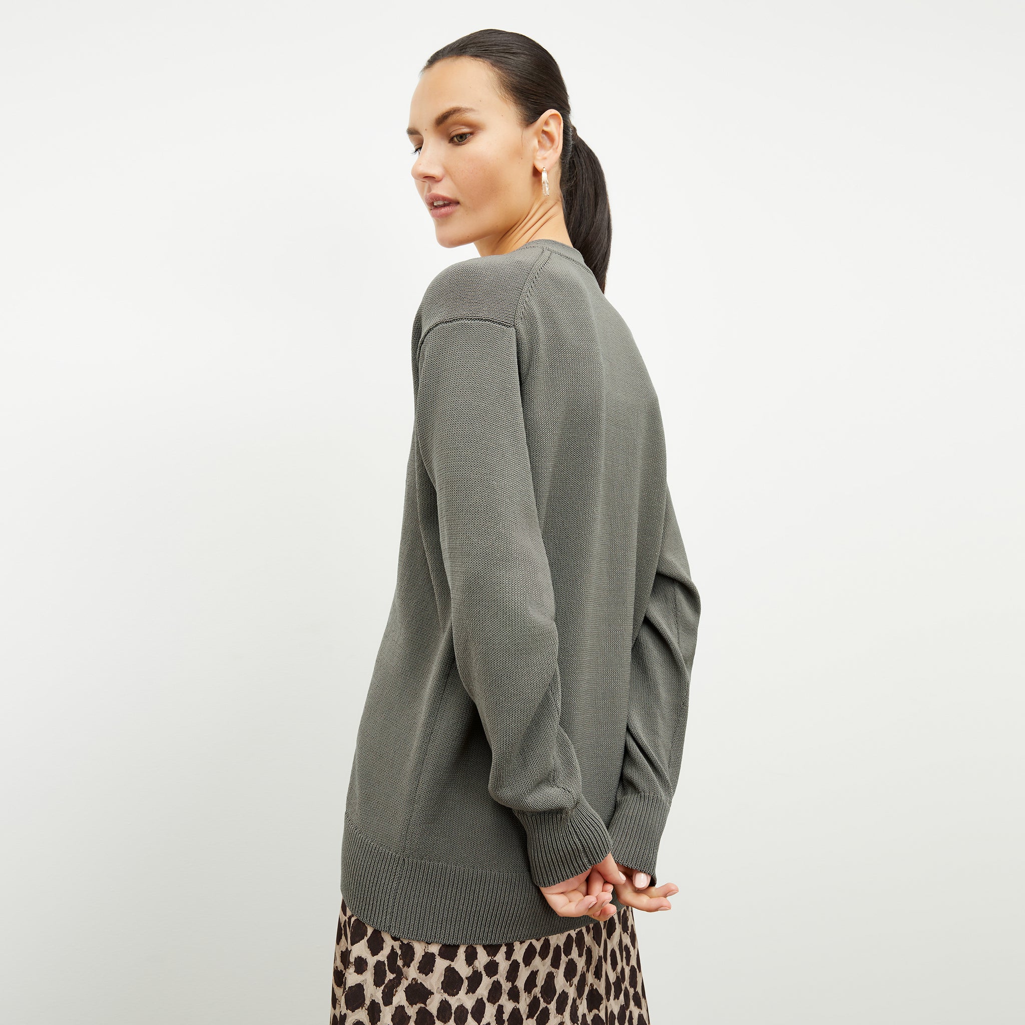 back image of a woman wearing the cookie cardigan in fossil