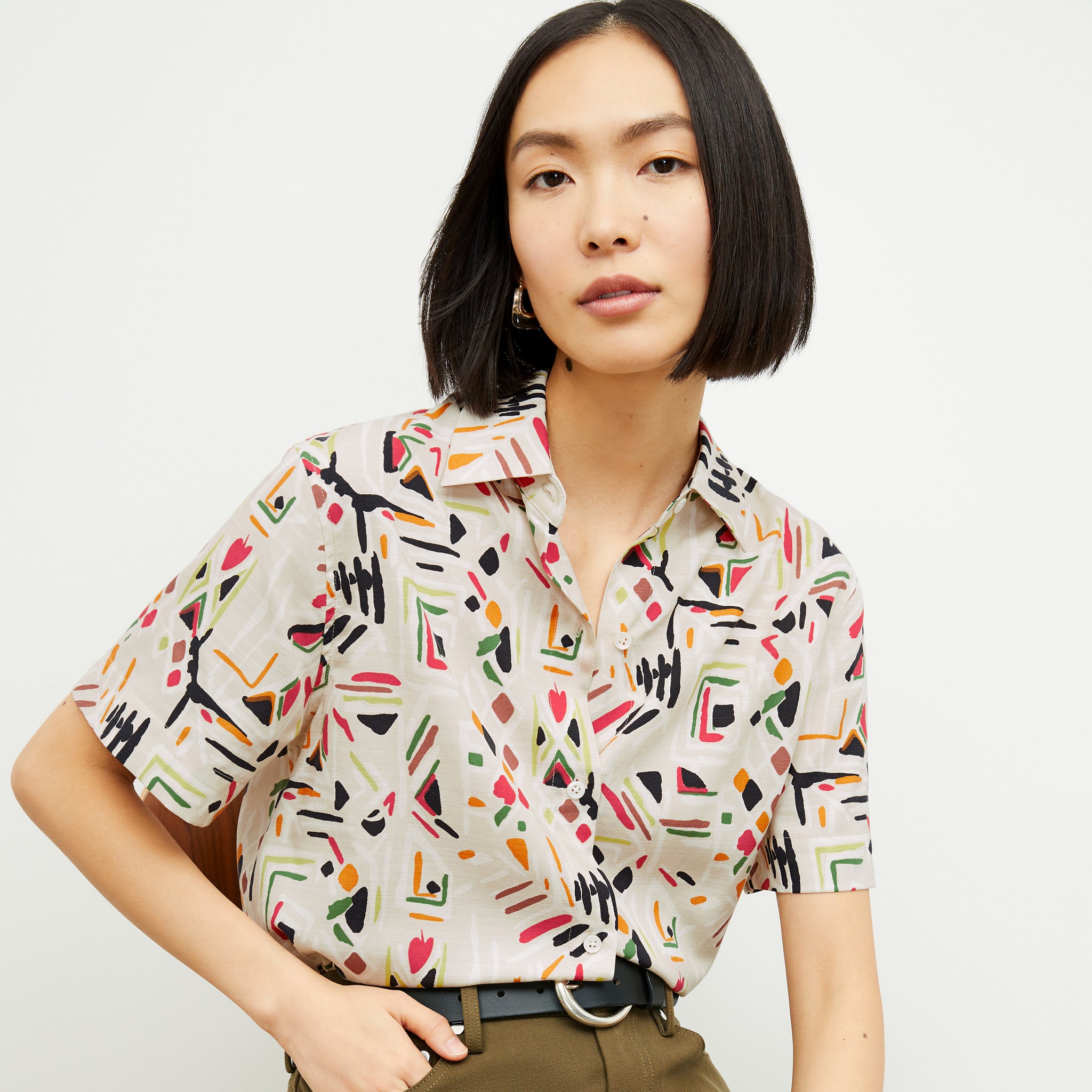front image of a woman wearing the livingston top in rhythm print
