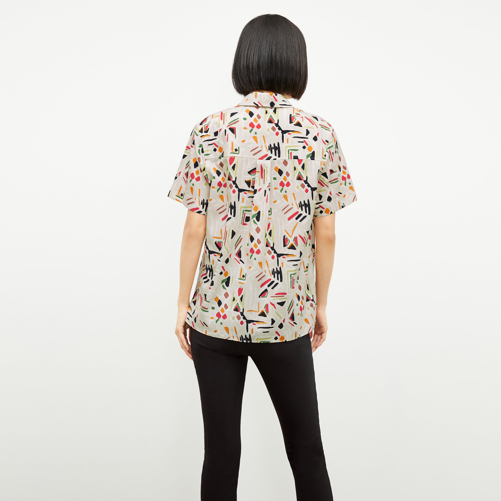 back image of a woman wearing the livingston top in rhythm print