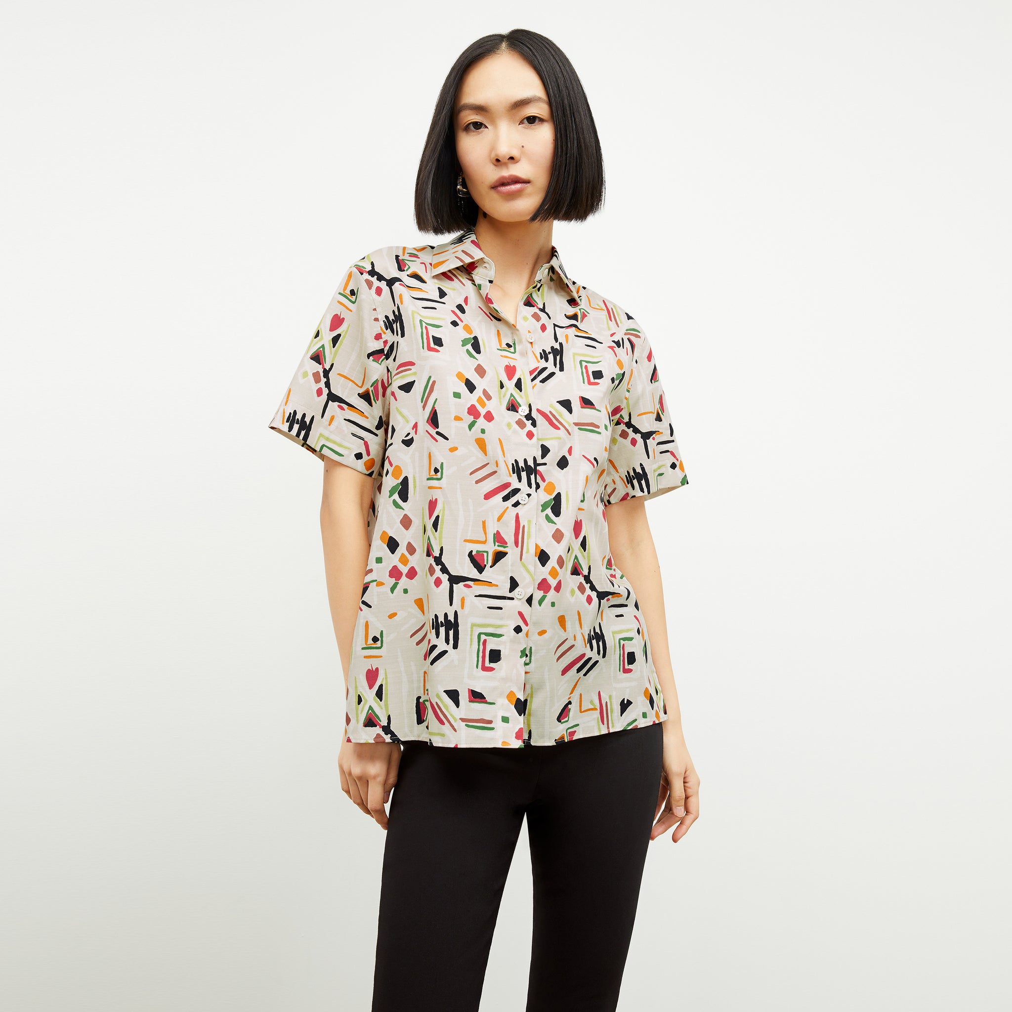 front image of a woman wearing the livingston top in rhythm print 
