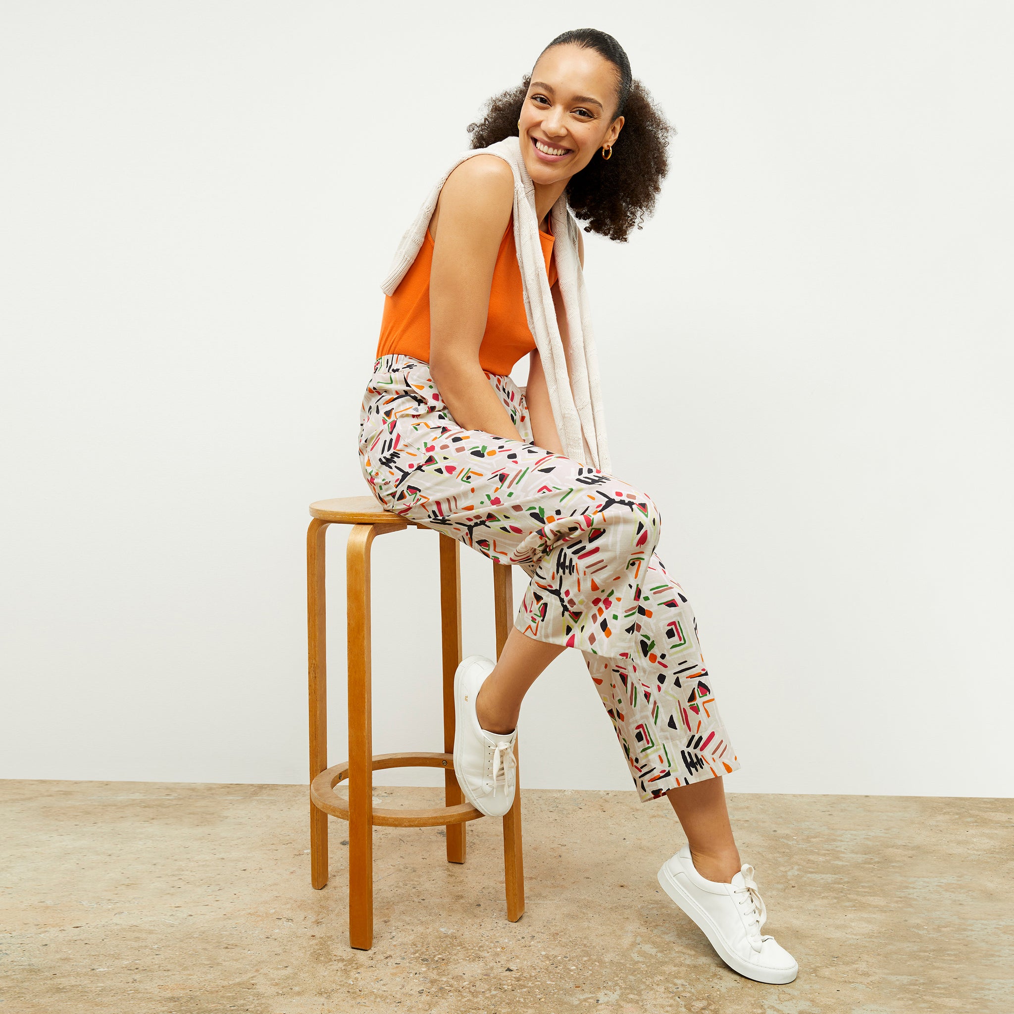 front image of a woman wearing the madelyn pant in rhythm print 