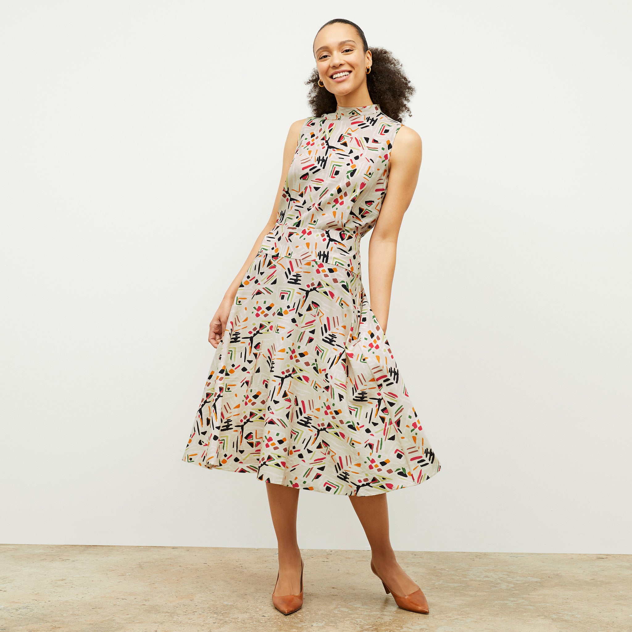 front image of a woman wearing the oona dress in rhythm print 