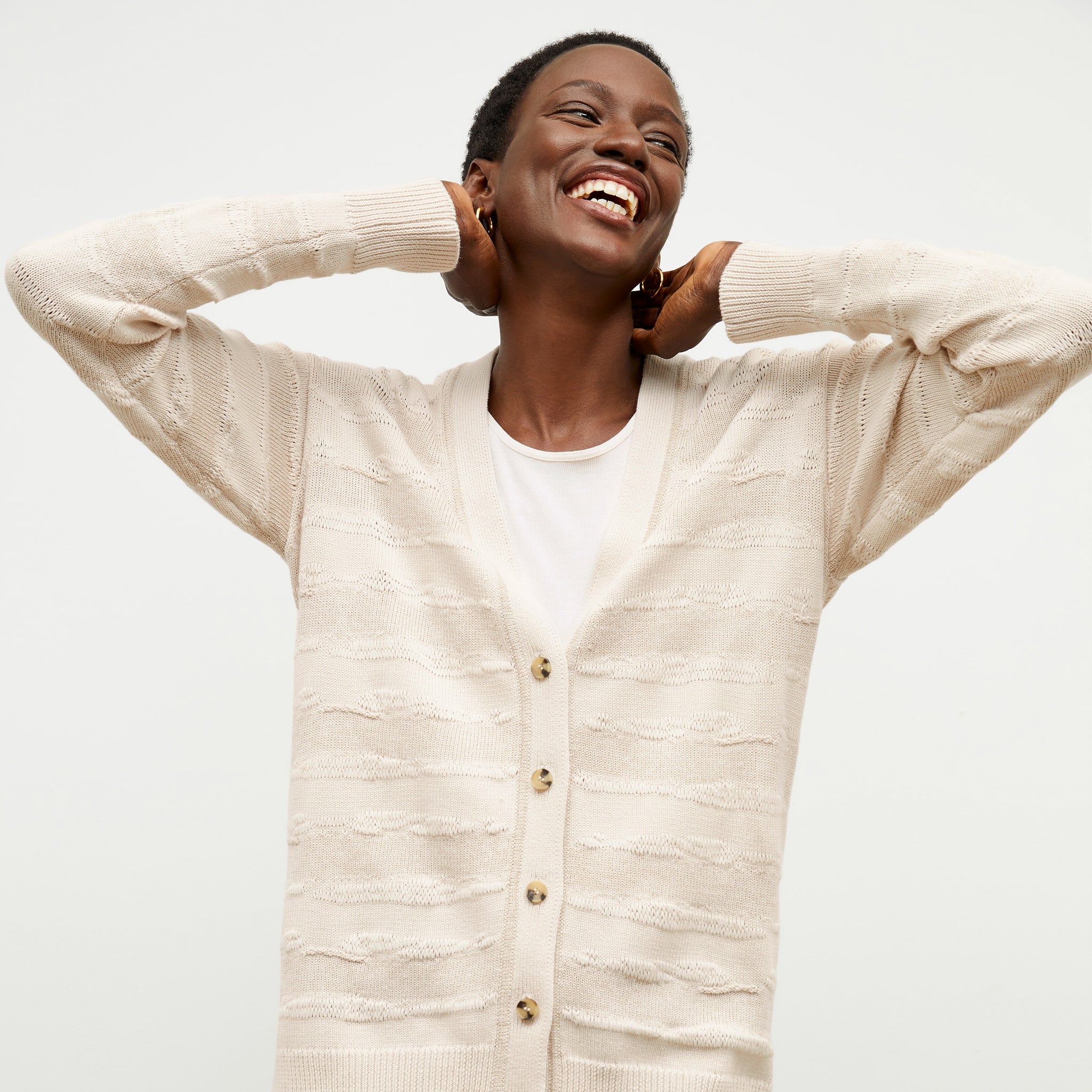 front image of a woman wearing the cookie cardigan in moonbeam