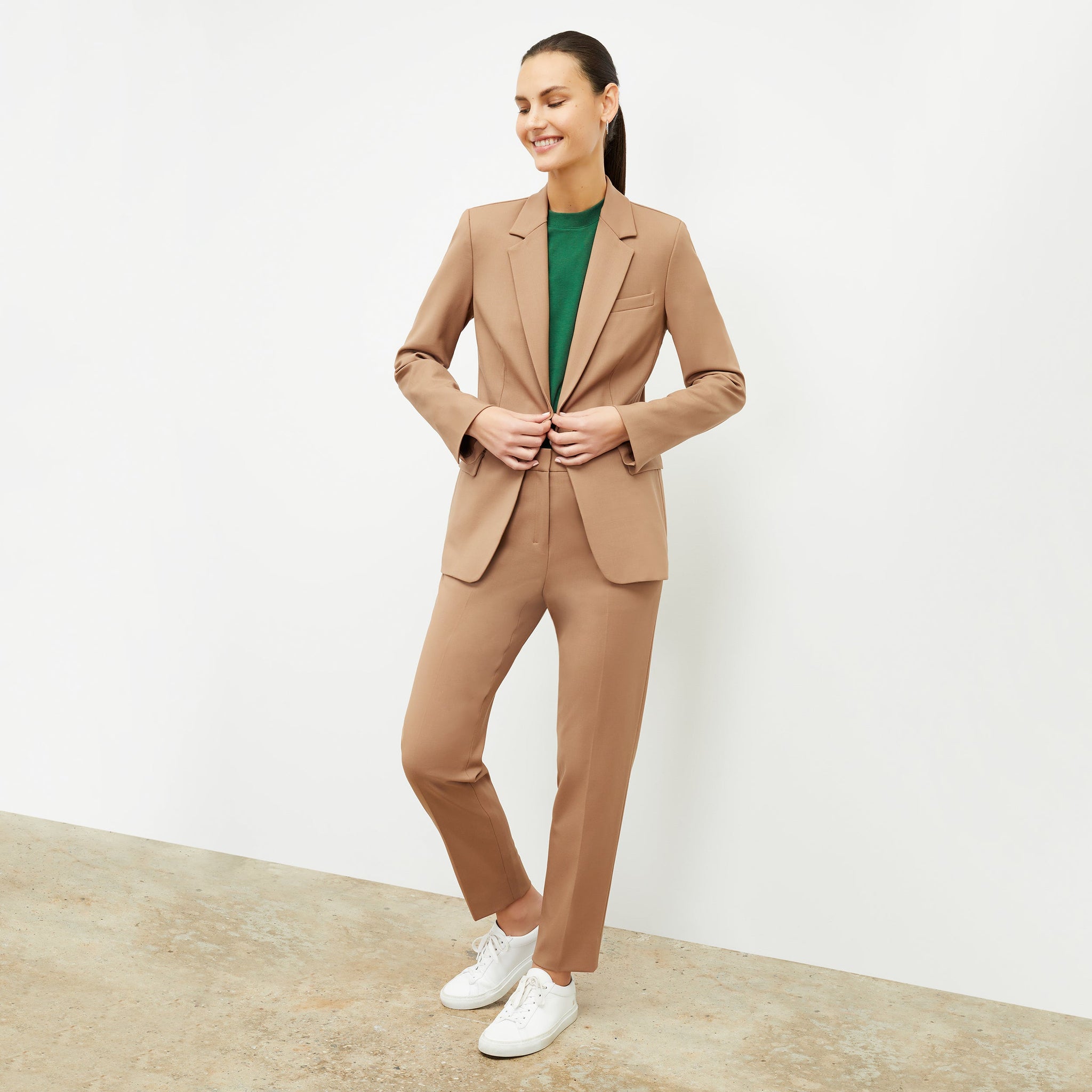 Front image of a woman wearing the yiyan blazer in camel