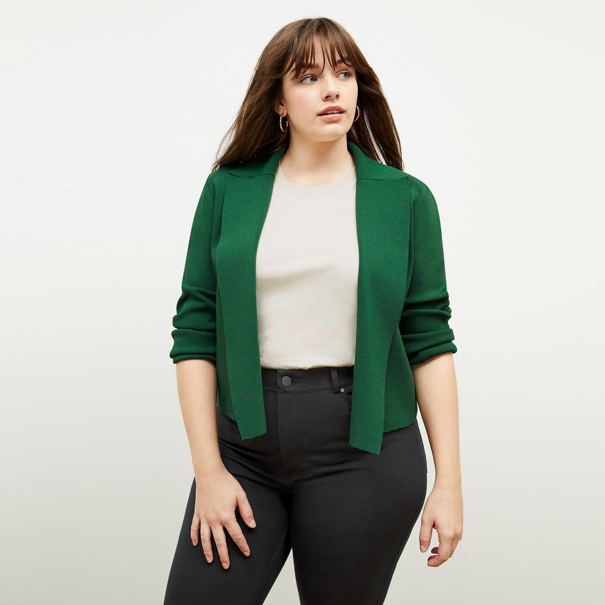 Front image of a woman standing wearing the leslie top in compact cotton in ivory