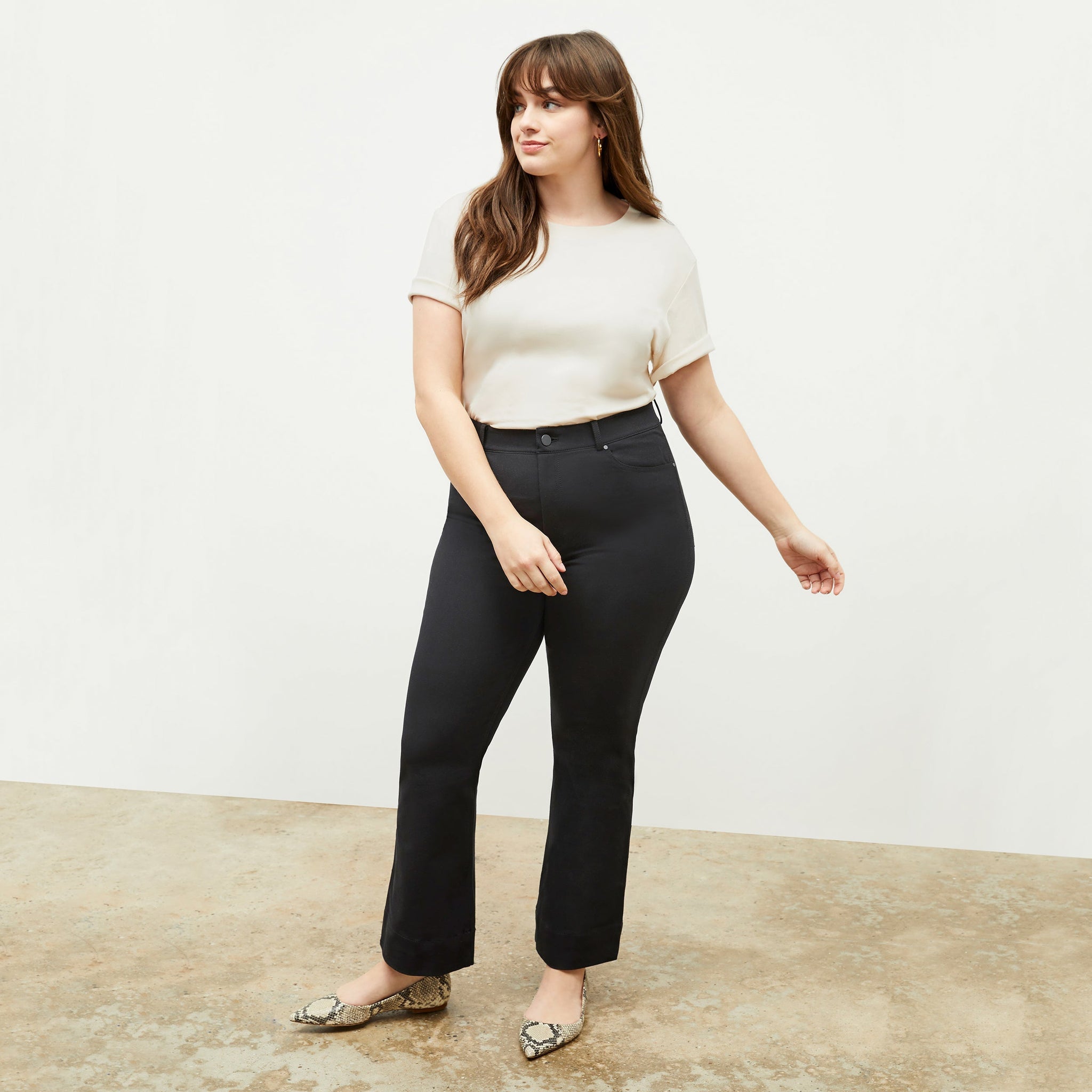 Front image of a woman standing wearing the leslie top in compact cotton in ivory