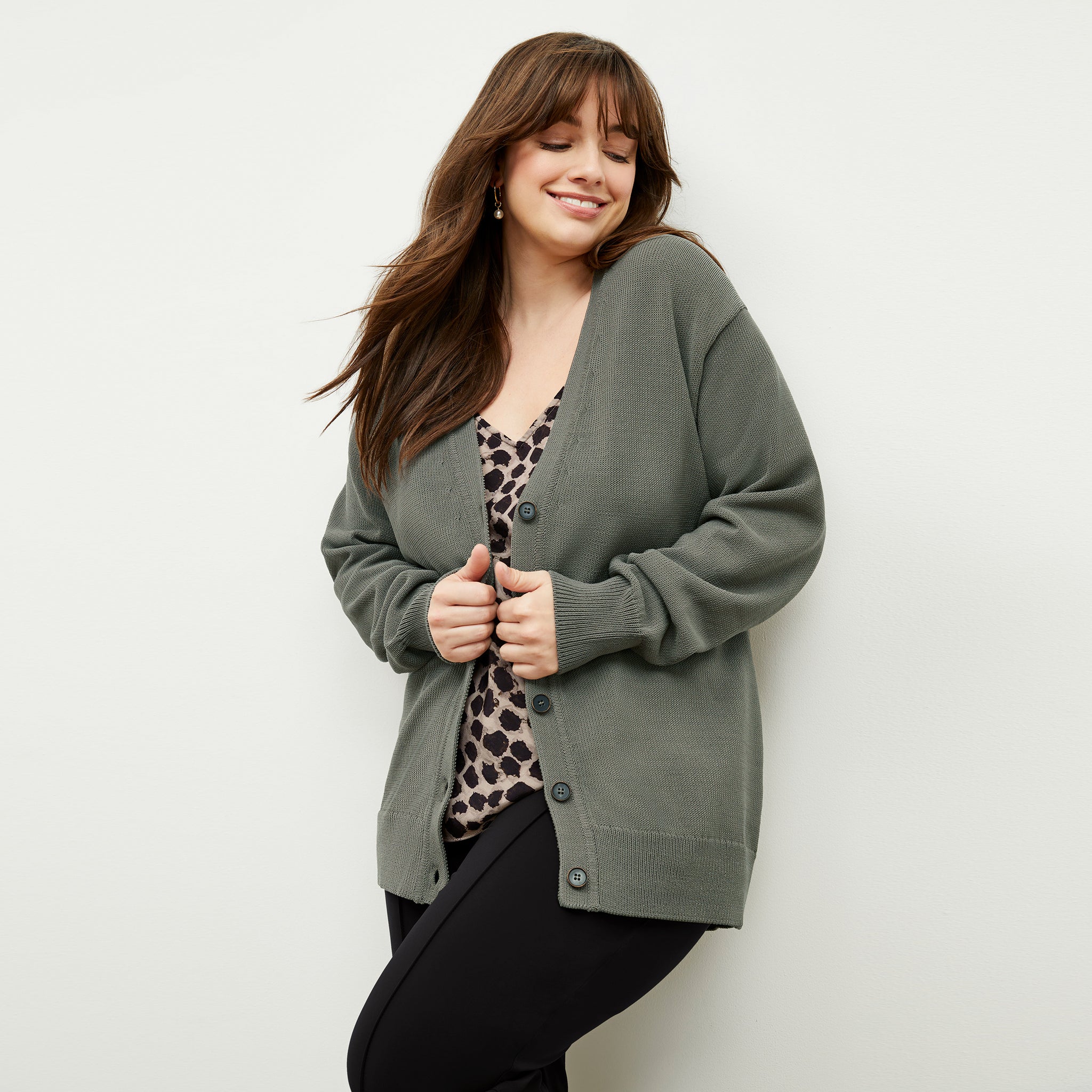 front image of a woman wearing the cookie cardigan in fossil