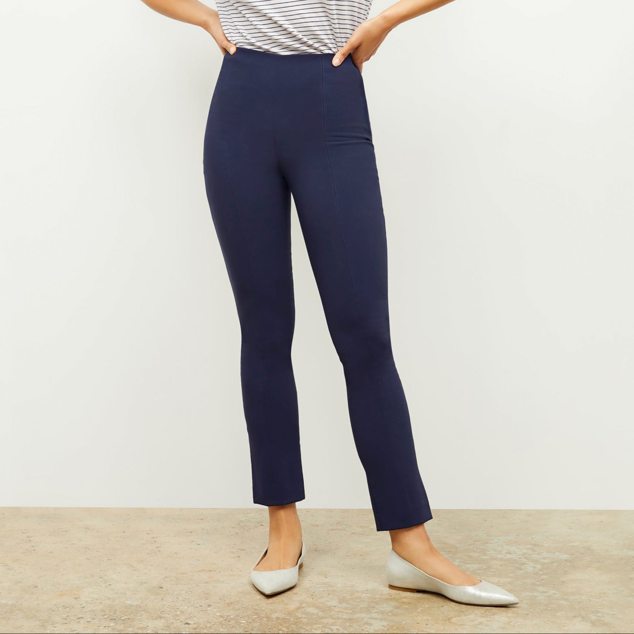Front image of a woman standing wearing the foster pant in dark navy 