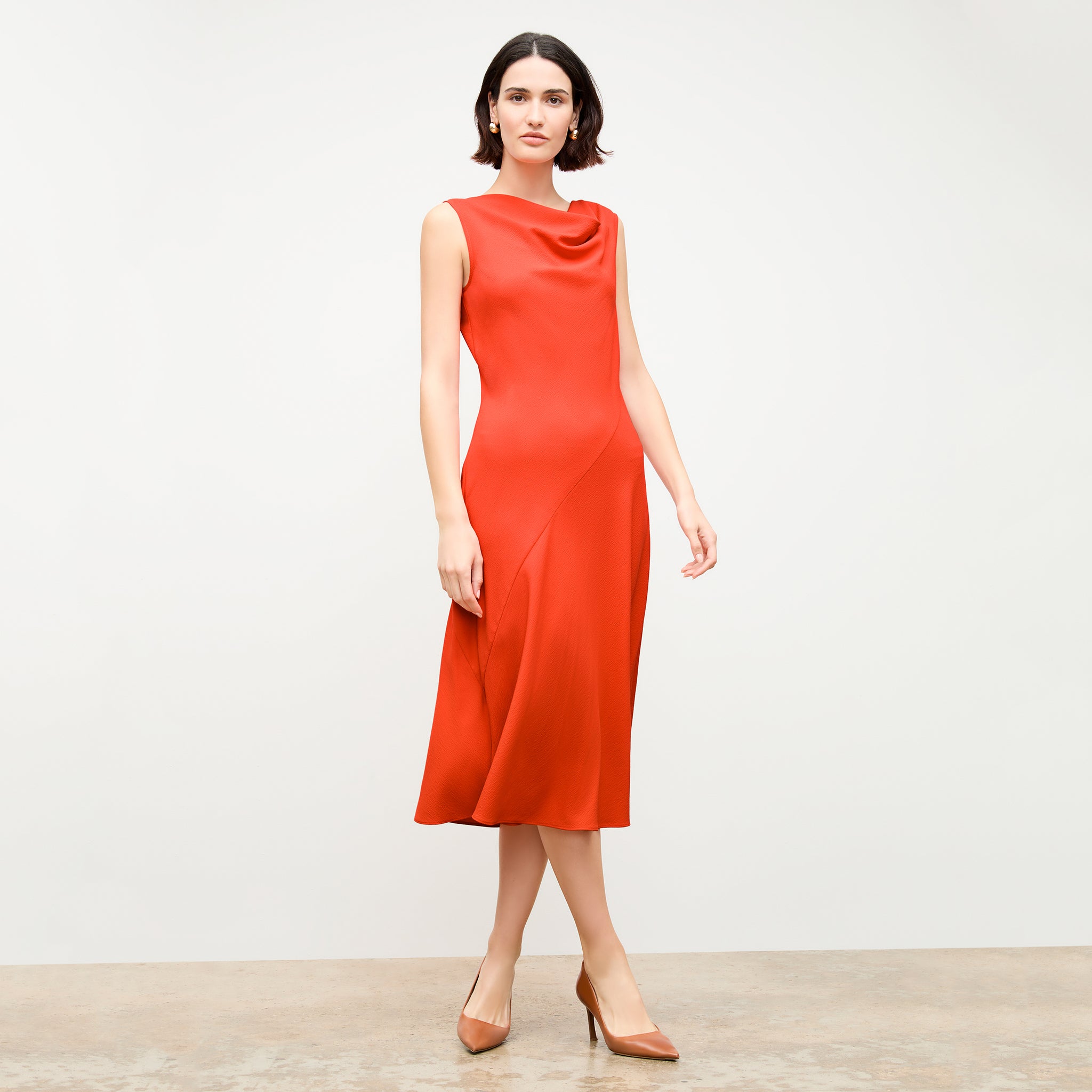 front image of a woman wearing the priya dress in bright coral