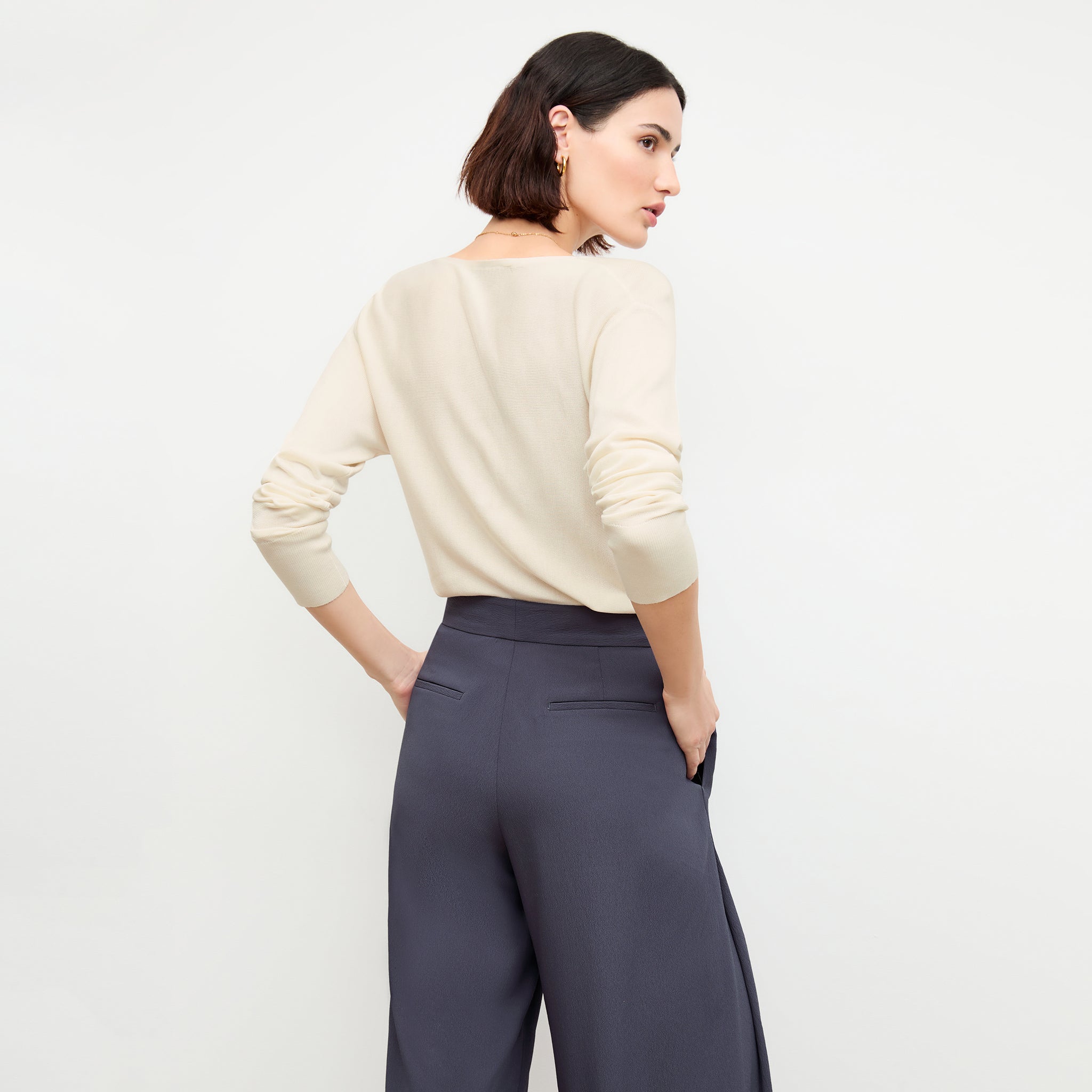 back image of a woman wearing the monica top in cream