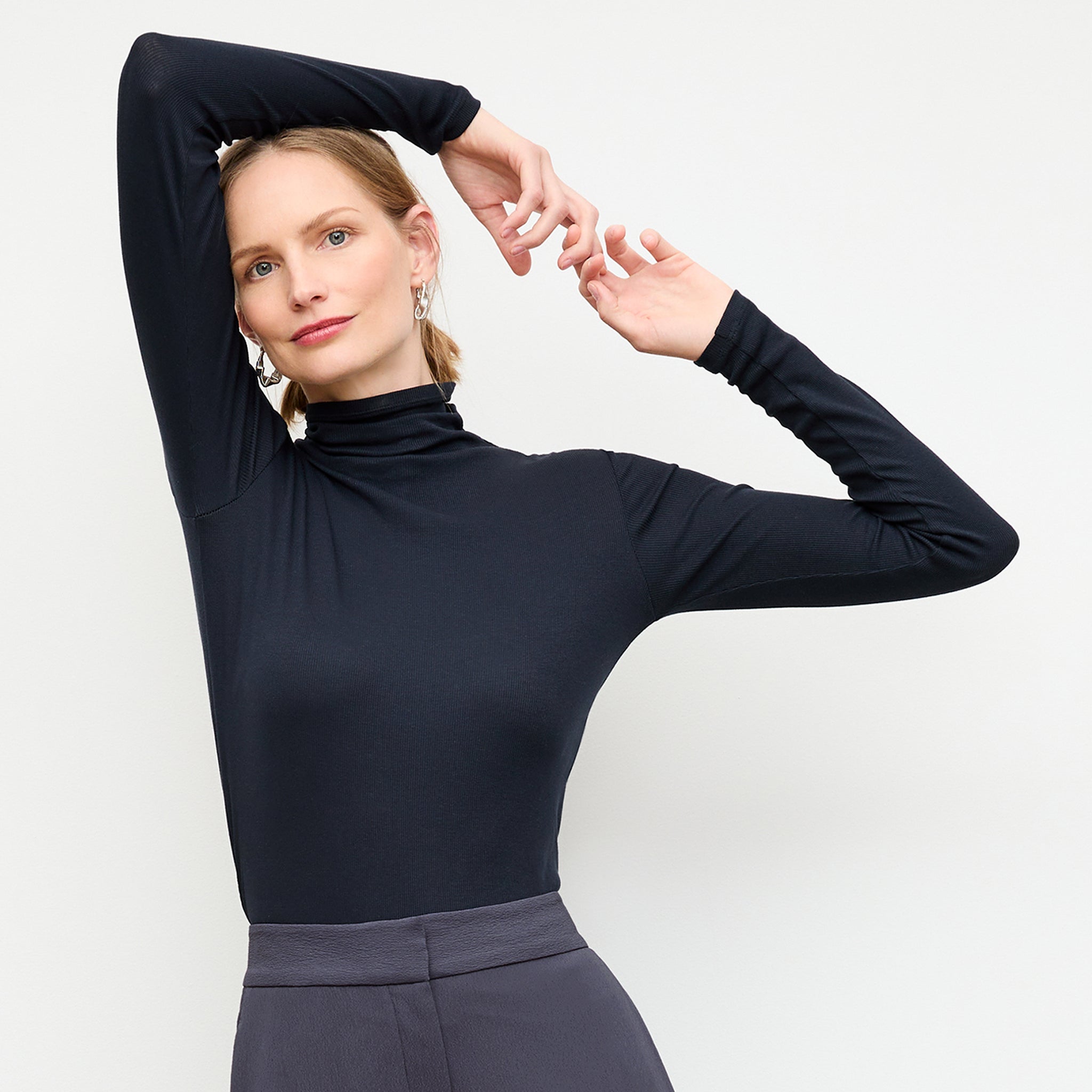 front image of a woman wearing the axam turtleneck in galaxy blue 