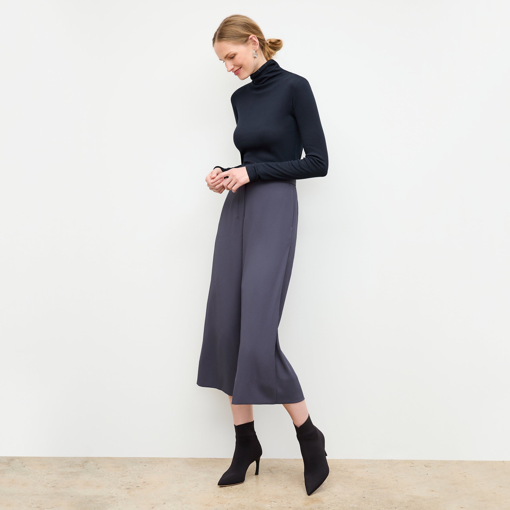 side image of a woman wearing the axam turtleneck in galaxy blue