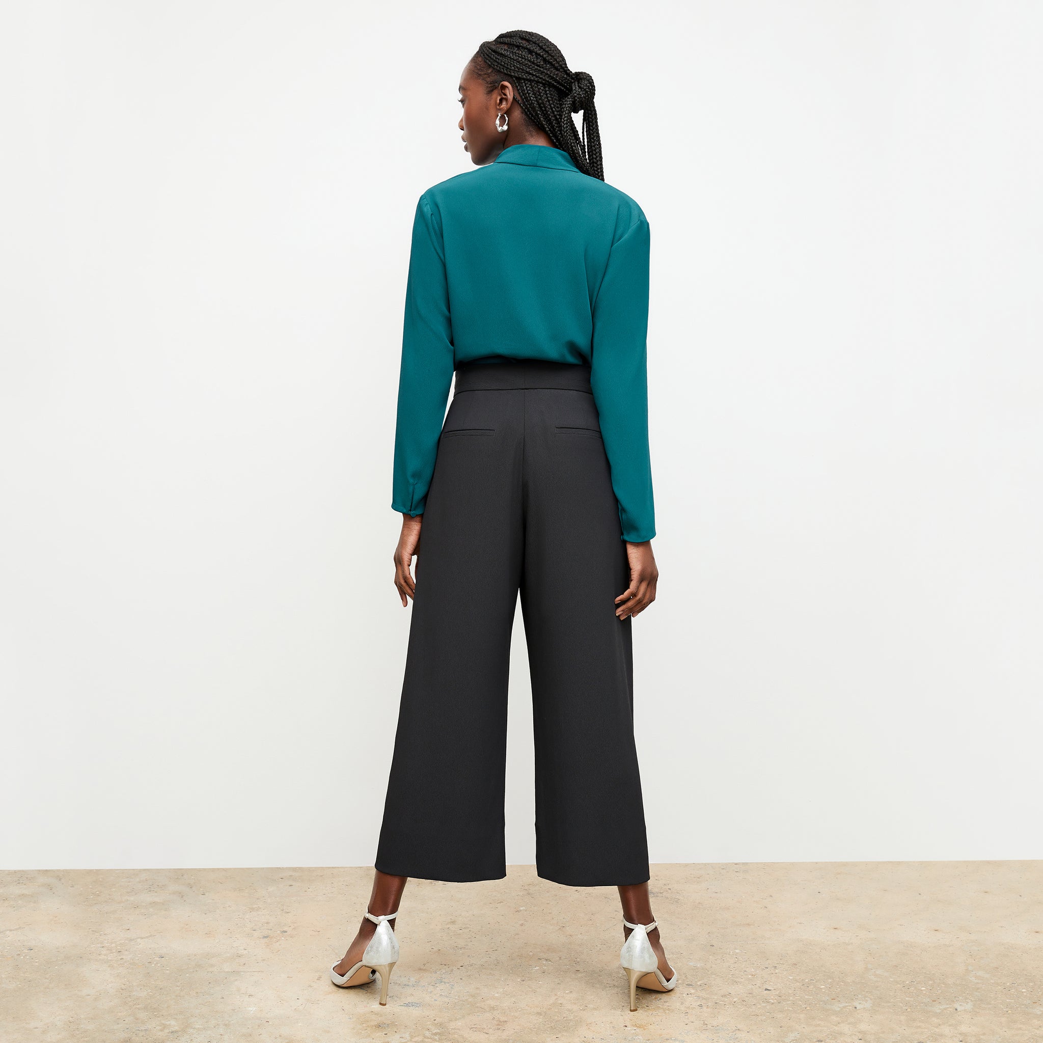 Back image of a woman standing wearing the Zhou culotte in black