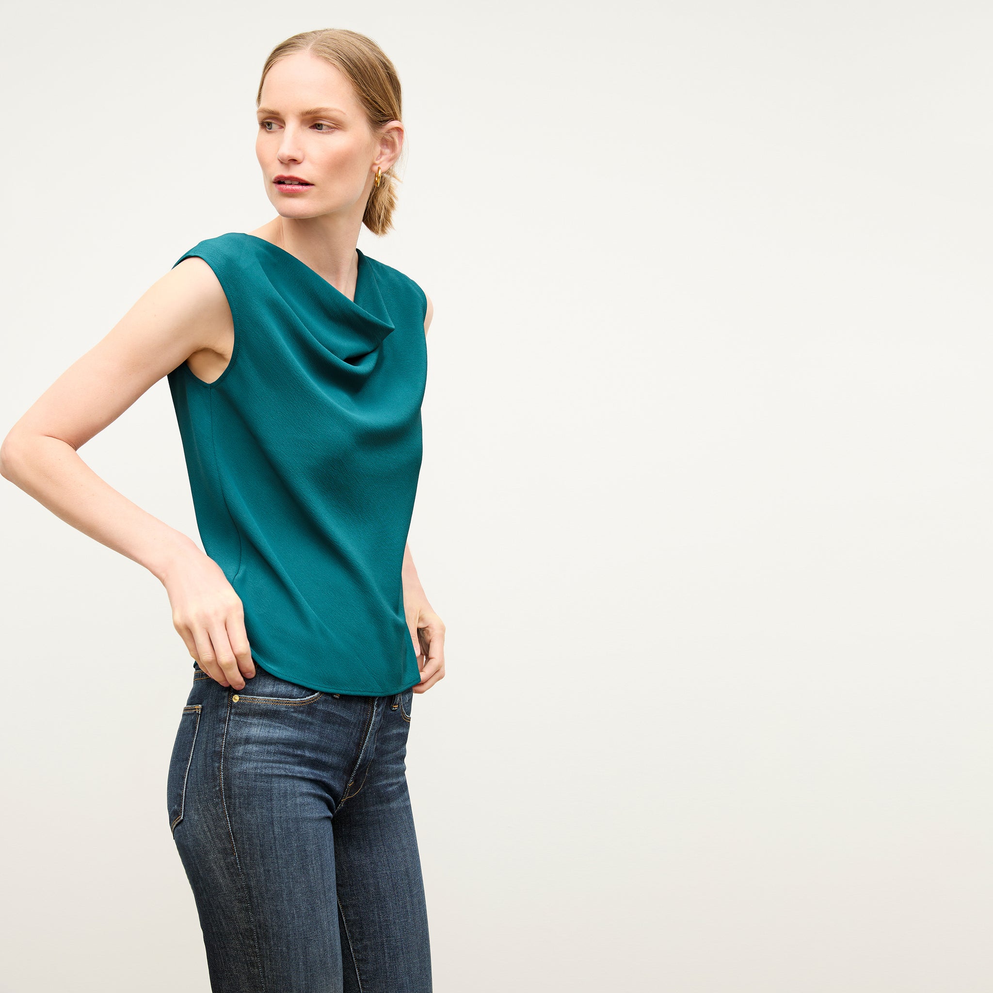 front image of a woman wearing the nora top in mineral blue