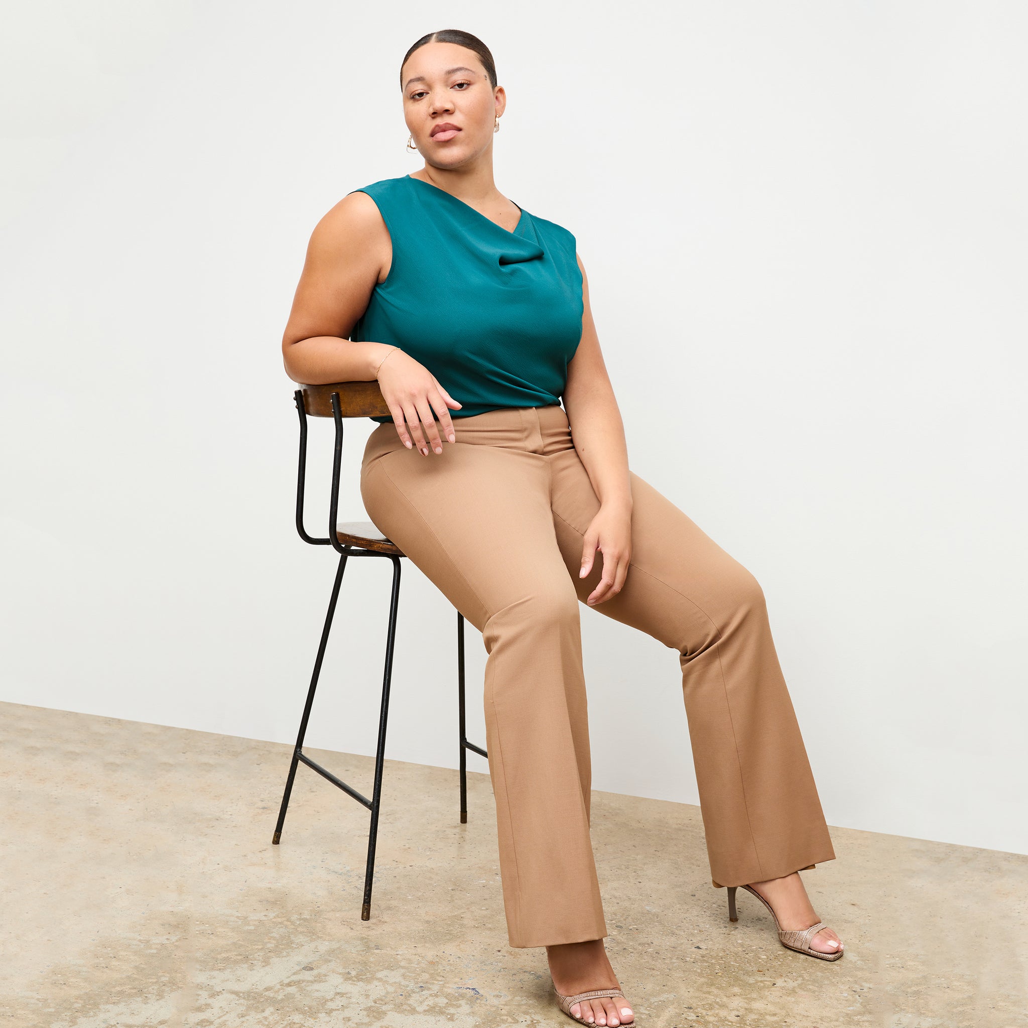 Front image of a woman wearing the Horton pant in camel