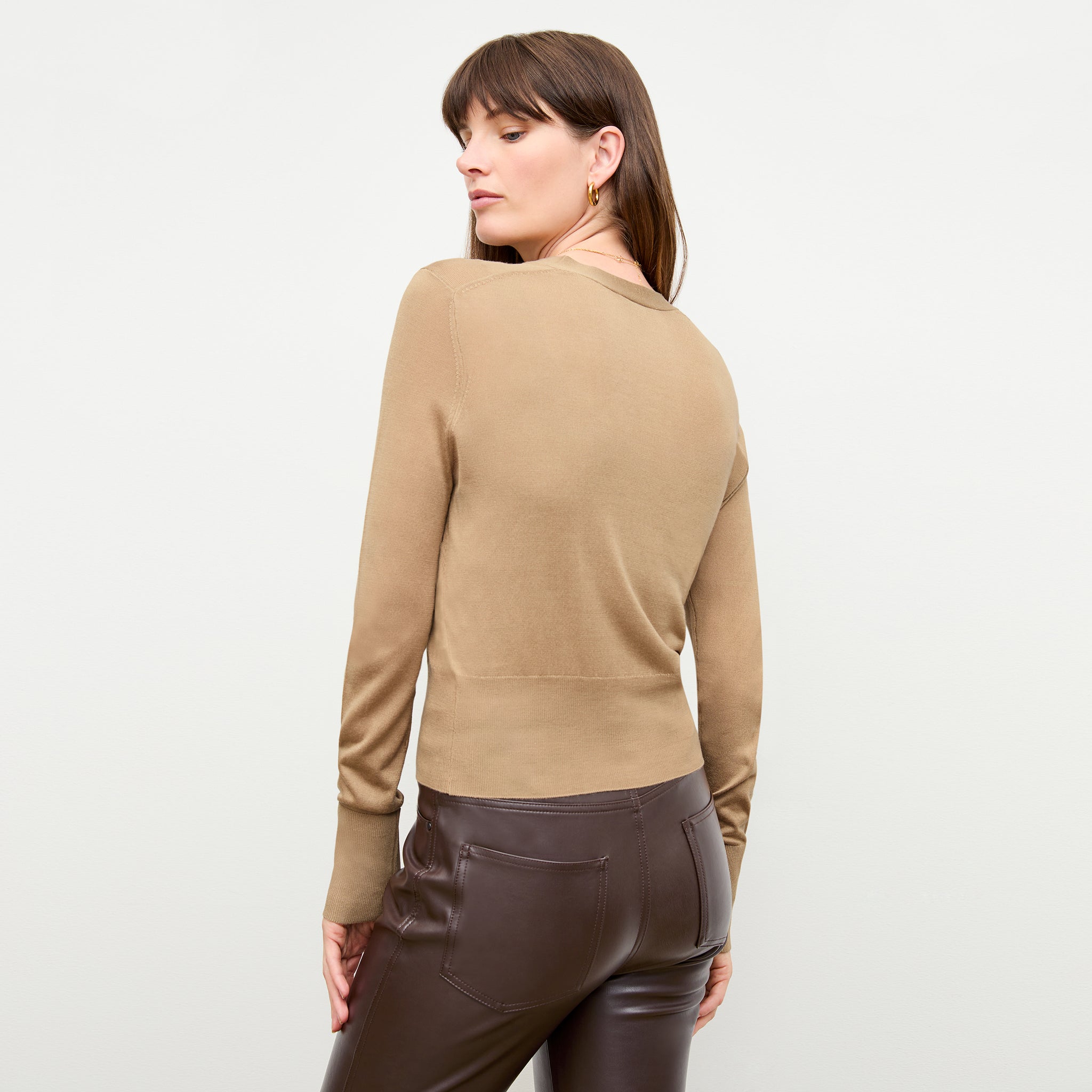 back image of a woman wearing the delphine top in camel