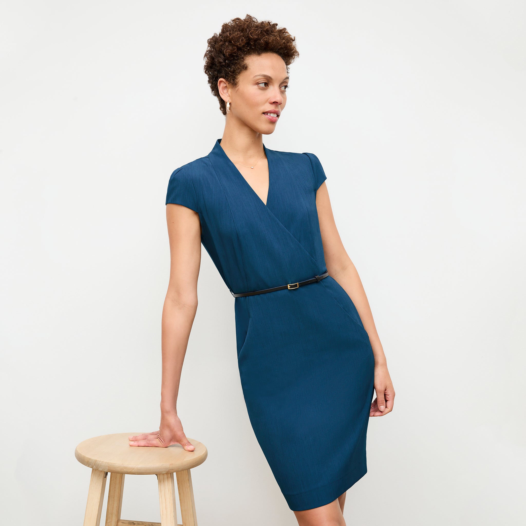 front image of a woman wearing the felisa dress in deep teal 