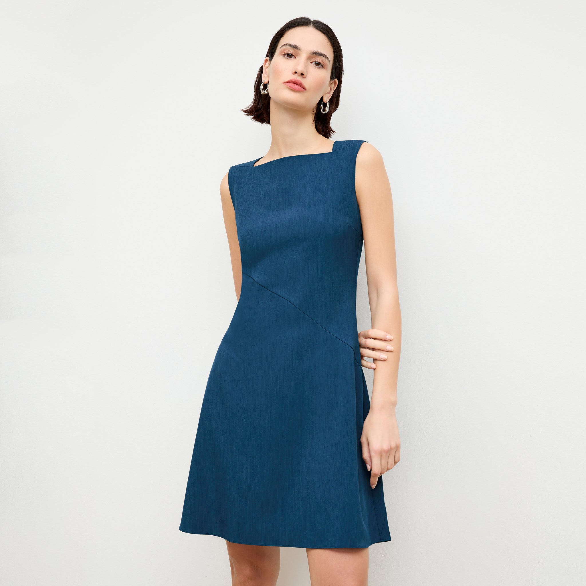 front image of a woman wearing the pauline dress in deep teal 