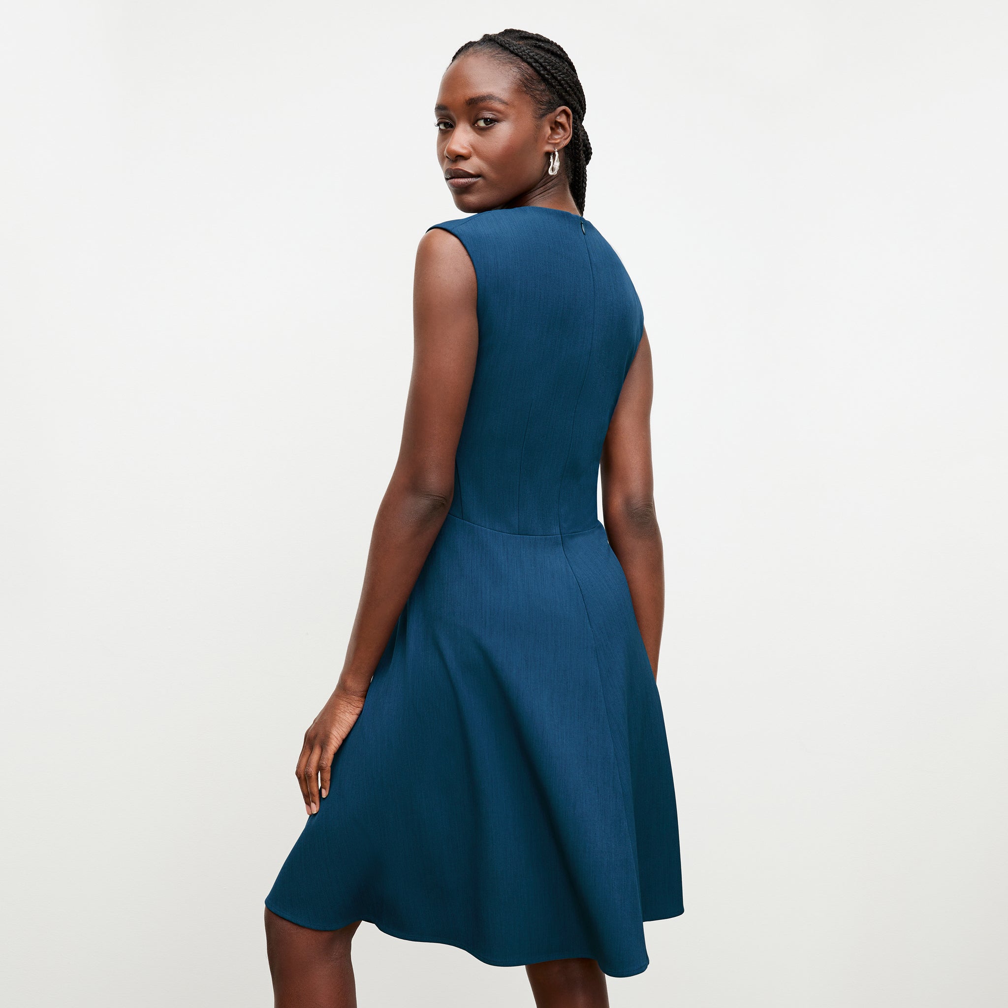 back image of a woman wearing the toi dress deep teal