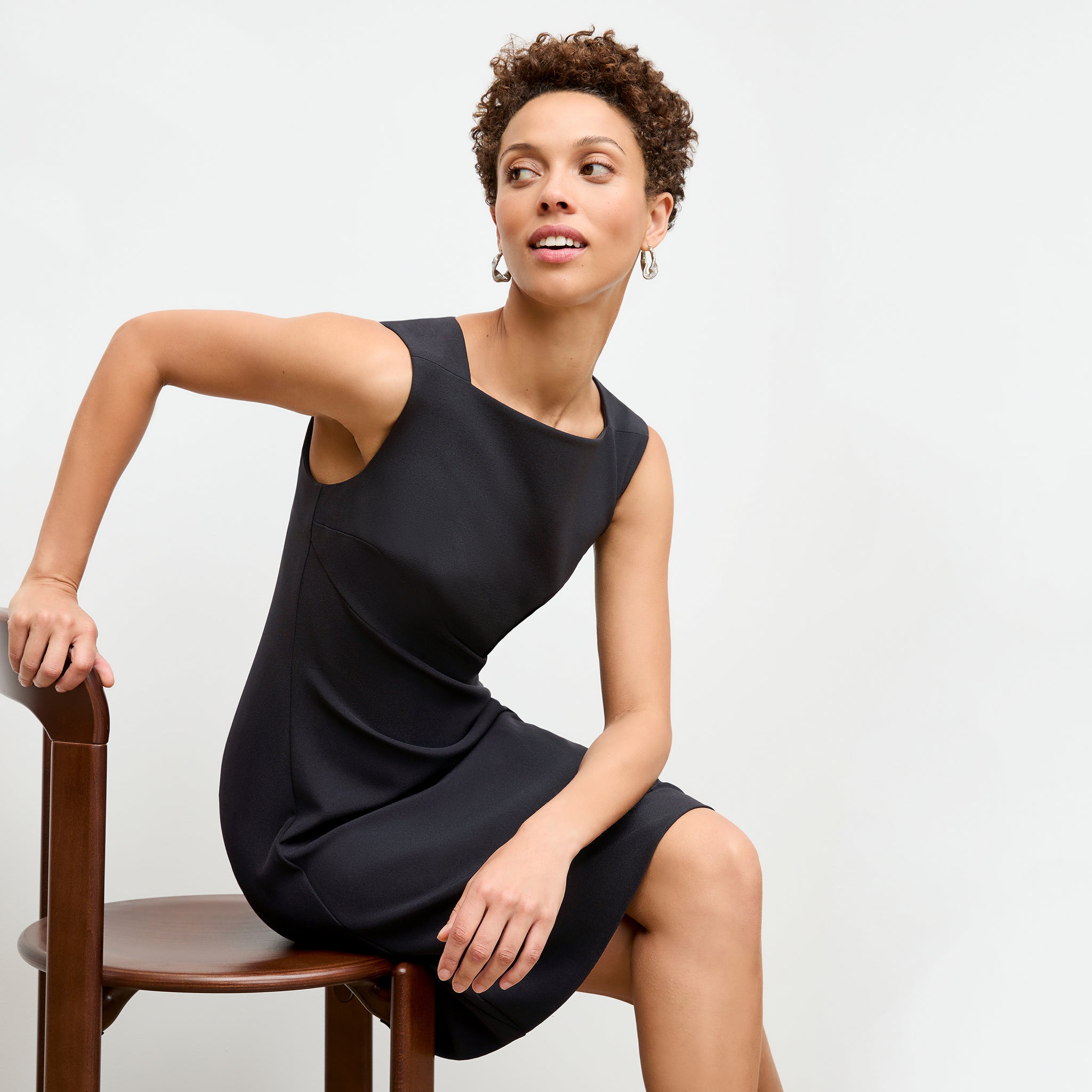 front image of a woman wearing the pauline dress in black
