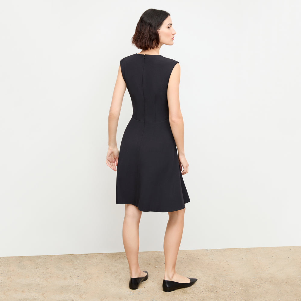 back image of a woman wearing the toi dress in black