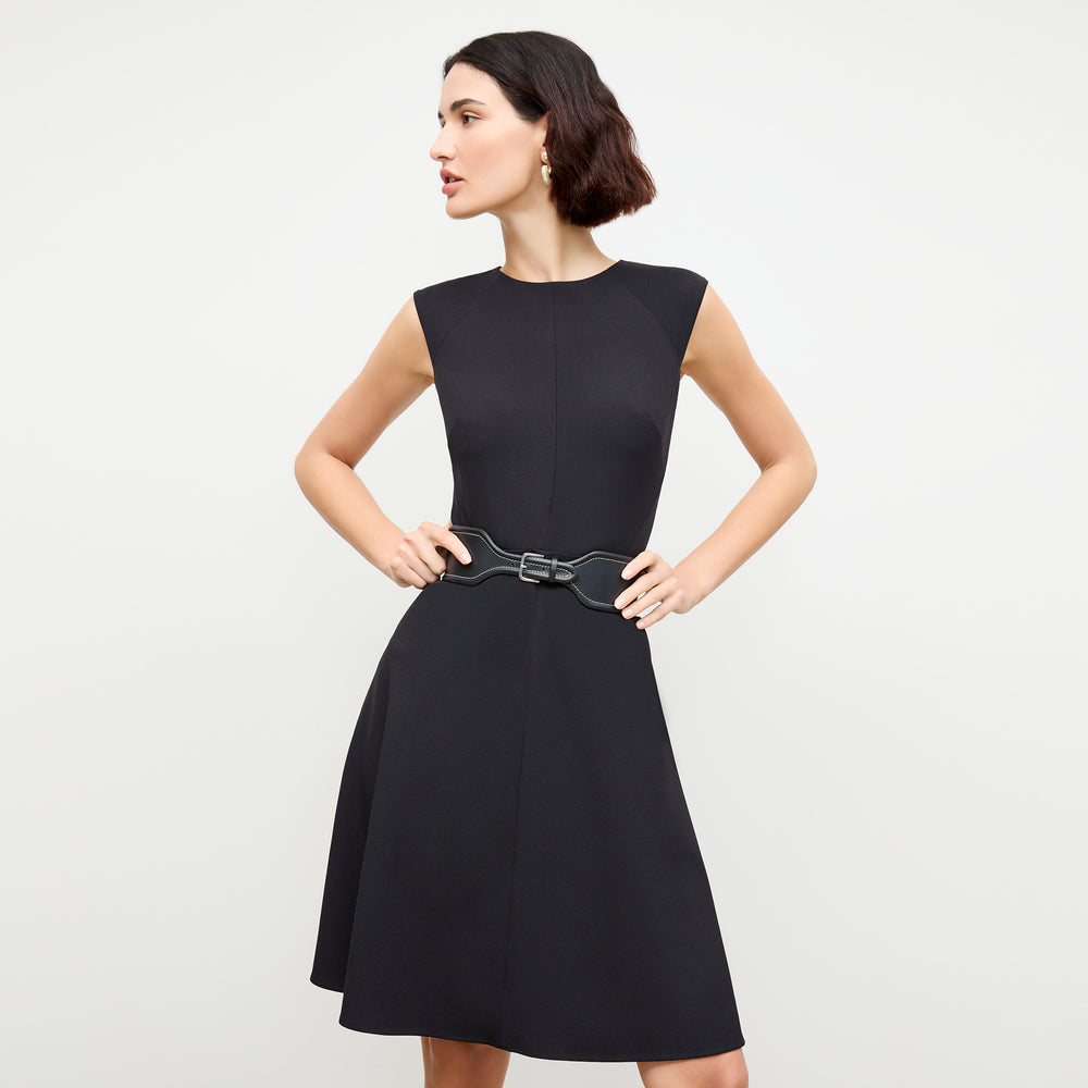 front image of a woman wearing the toi dress in black