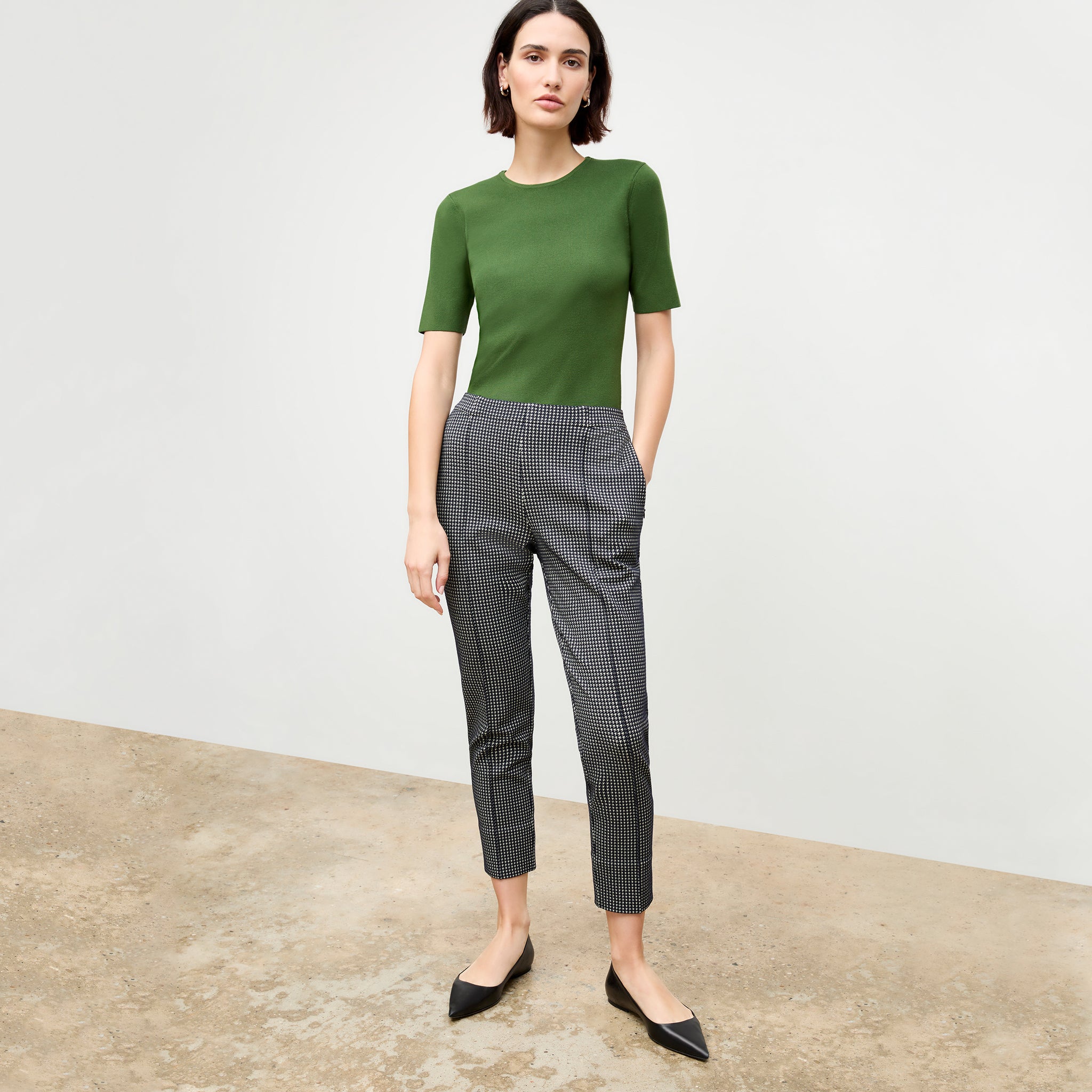 front image of a woman wearing the colby pant in stretch houndstooth 
