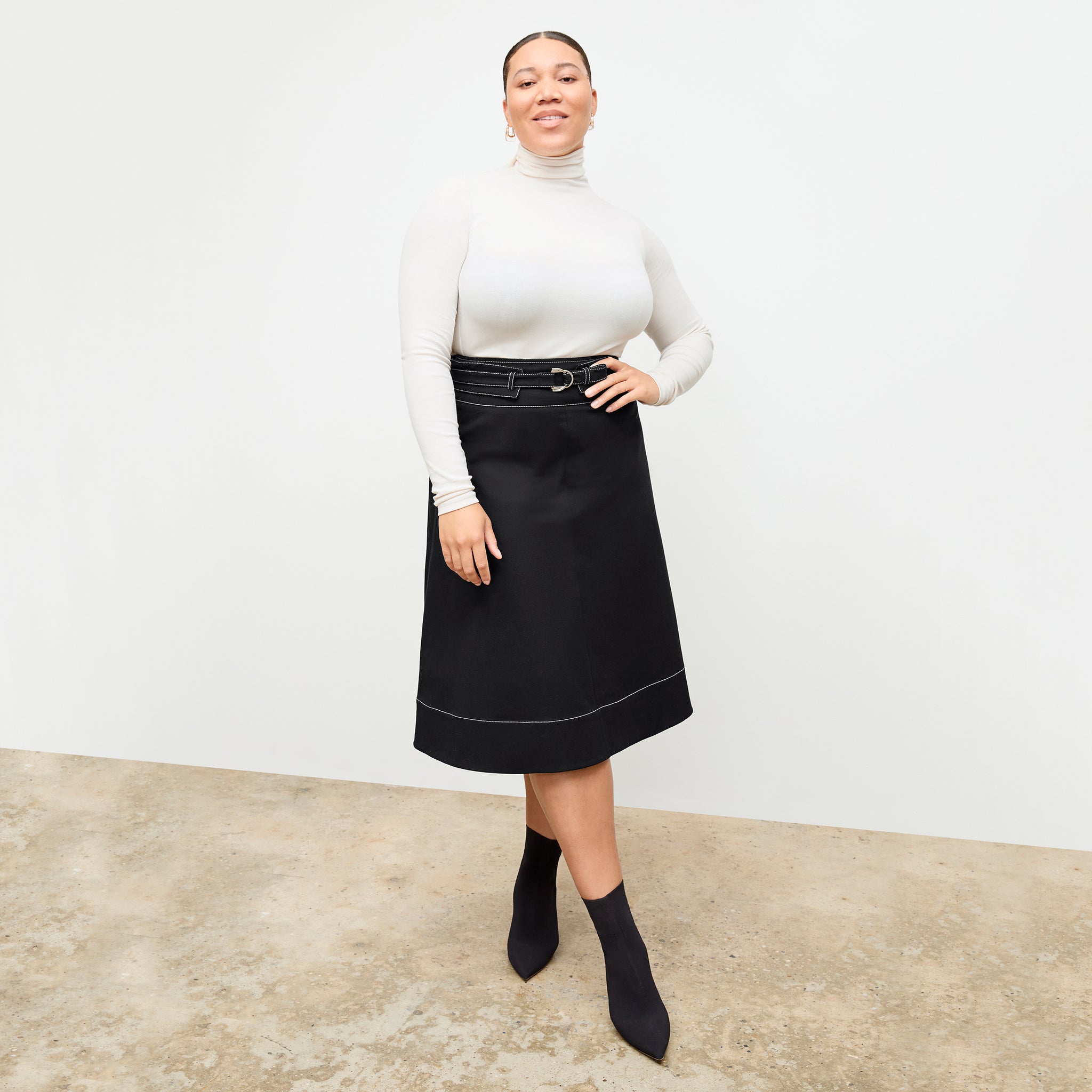 front image of a woman wearing the bodhi skirt in black