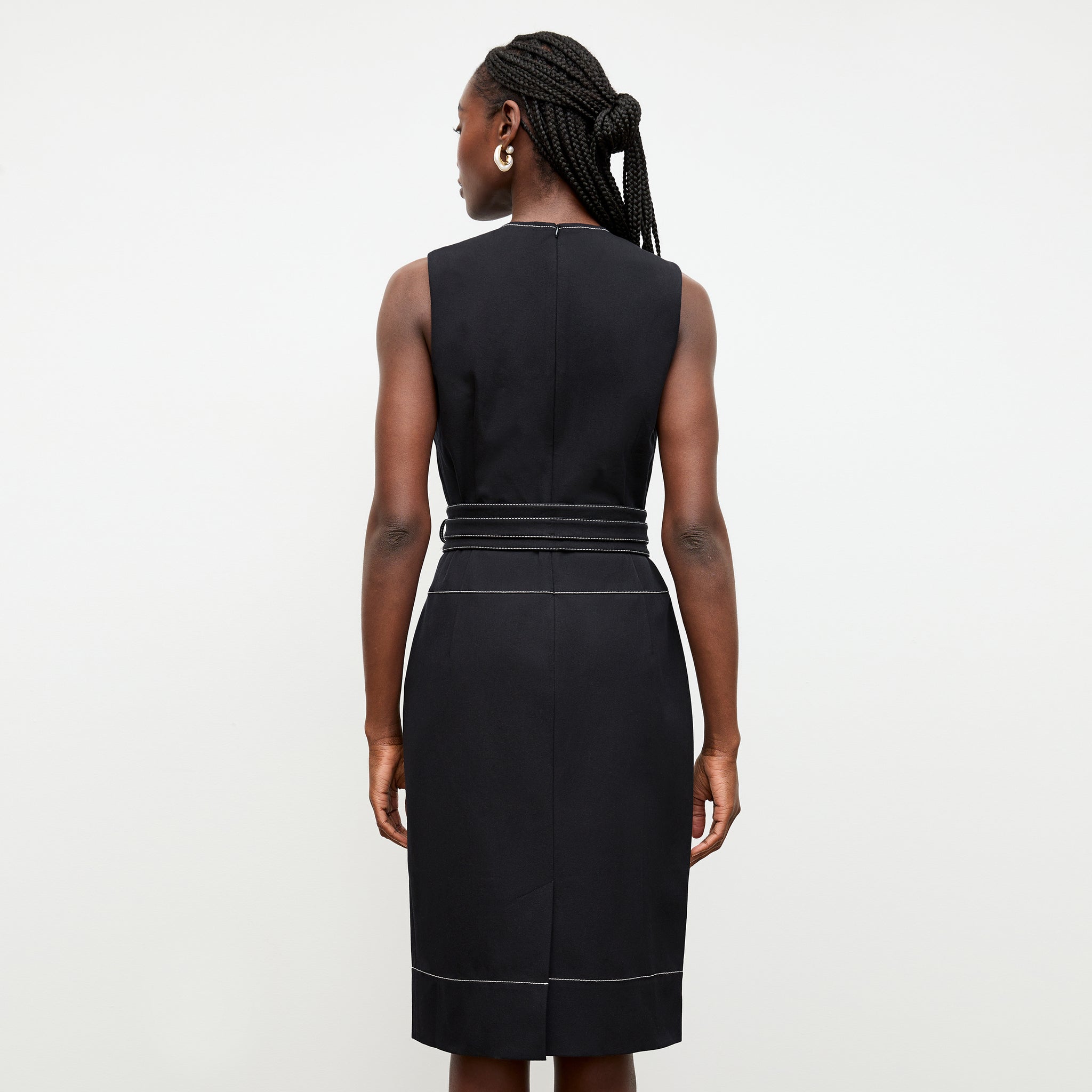 back image of a woman wearing the maude dress in black
