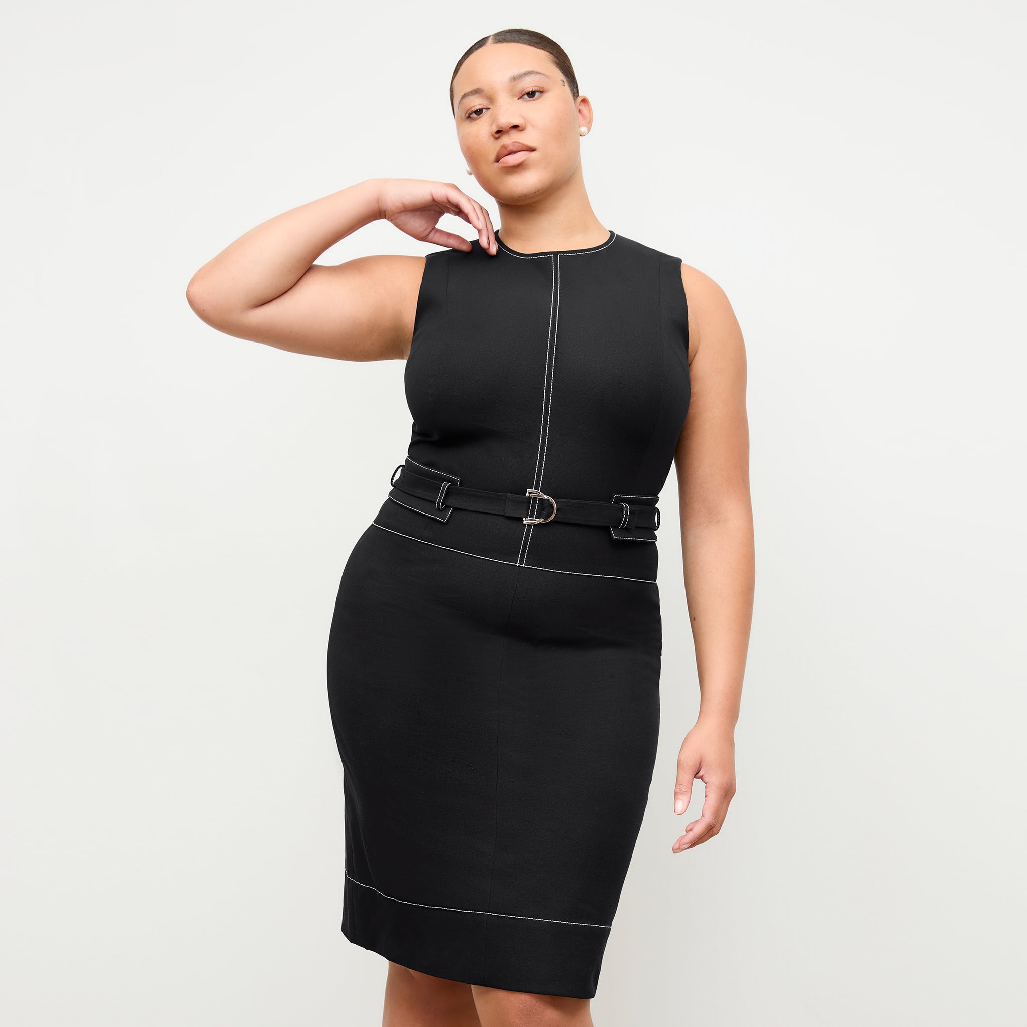 front image of a woman wearing the maude dress in black