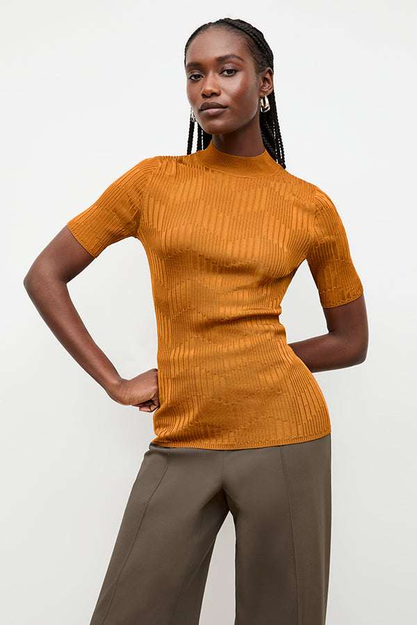 front image of a woman wearing the montean top in caramel
