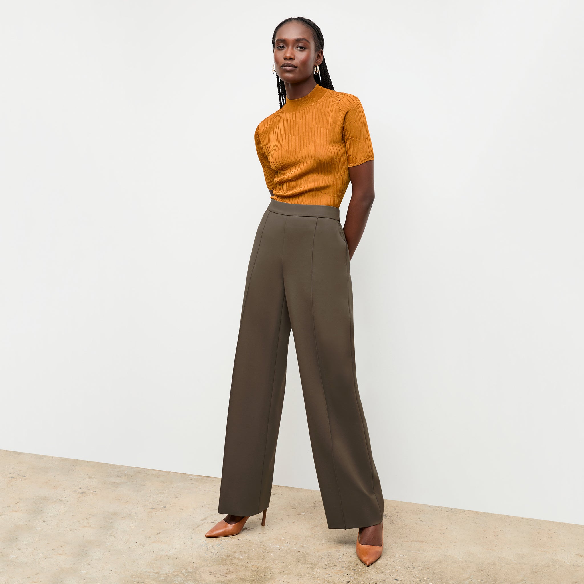 front image of a woman wearing the montean top in caramel 