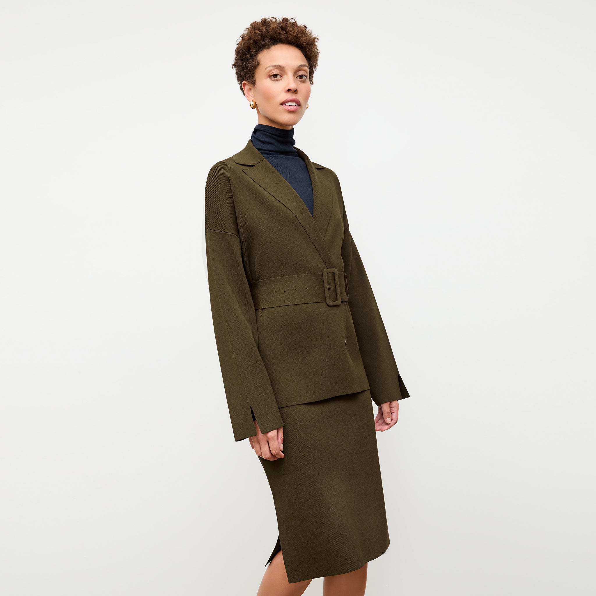 front image of a woman wearing the harlem skirt in dark elm