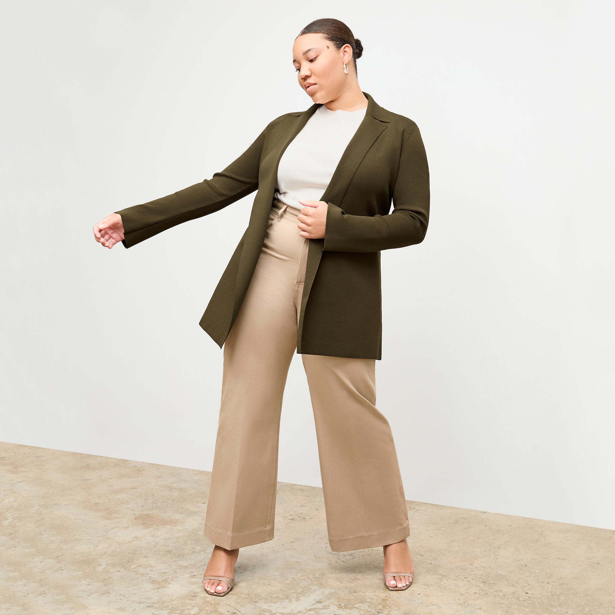 Front image of a woman standing wearing the Milo jean in Beige 