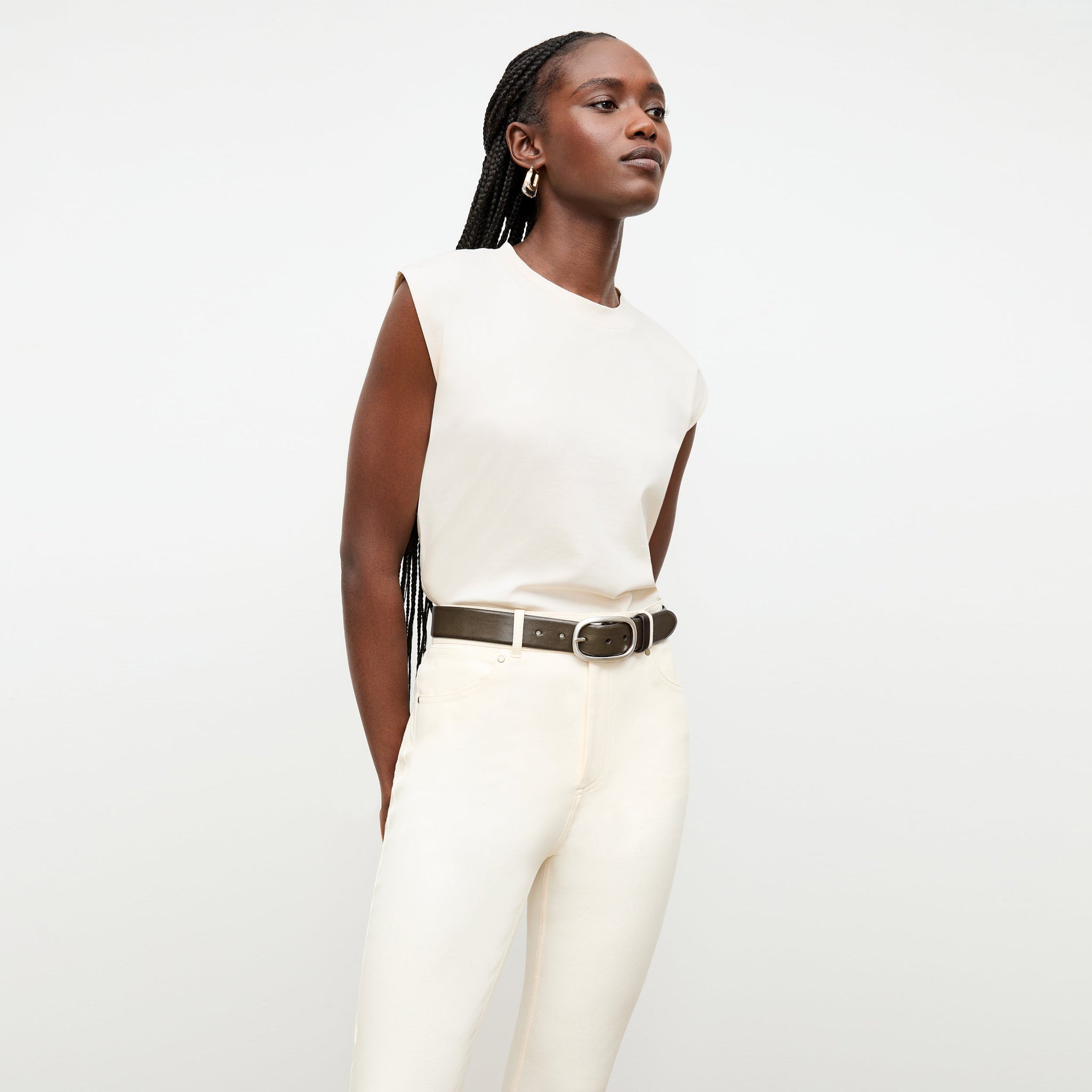 Front image of a woman standing wearing the alina top in compact cotton in ivory