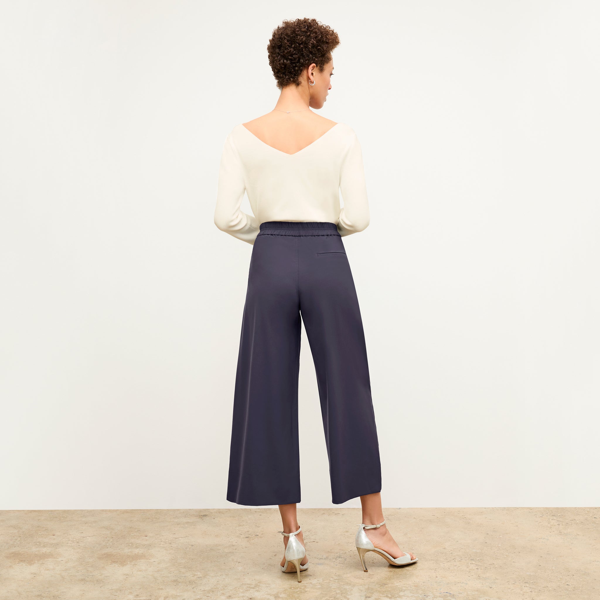 back image of a woman wearing the elena pant in cool charcoal