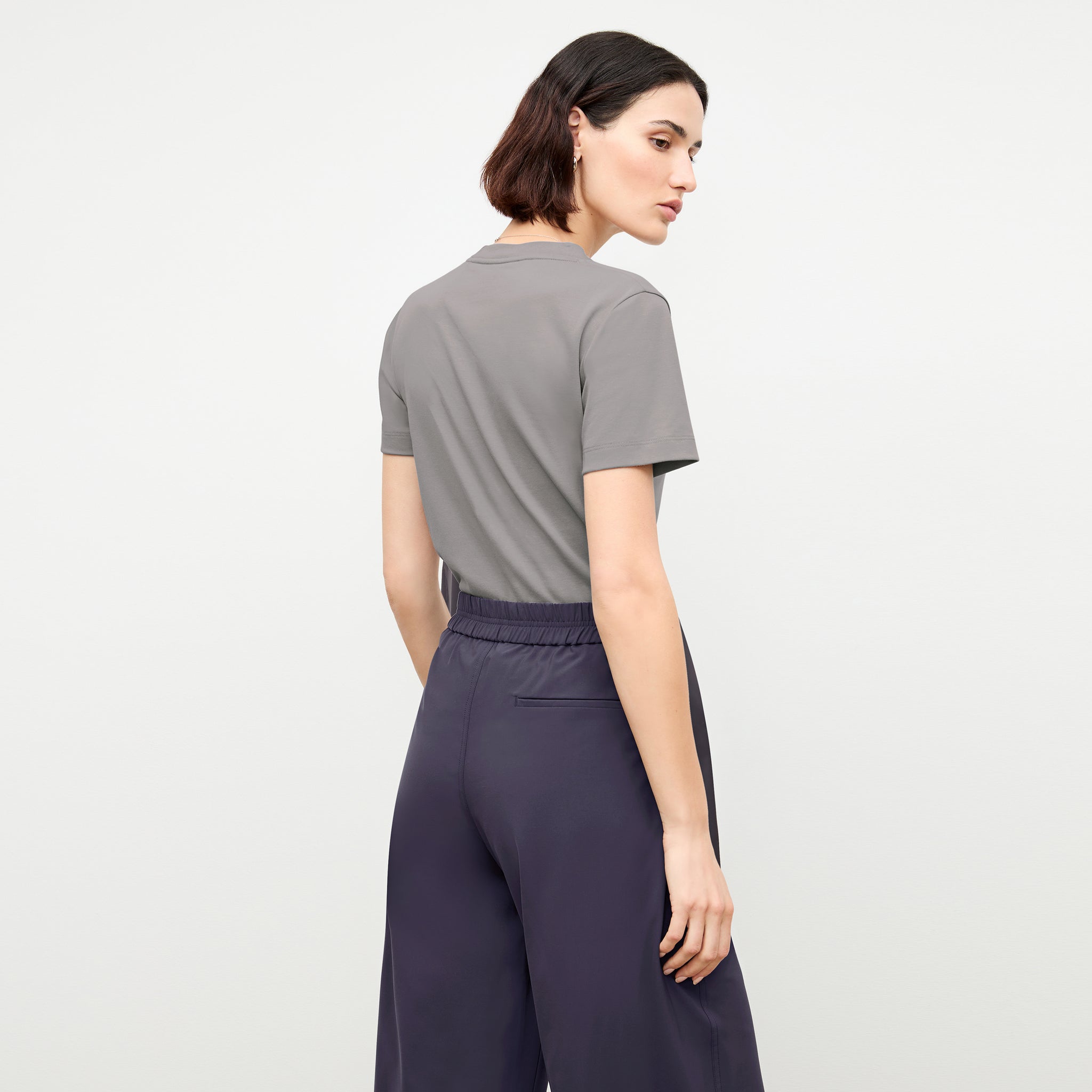 back image of a woman wearing the elena pant in cool charcoal